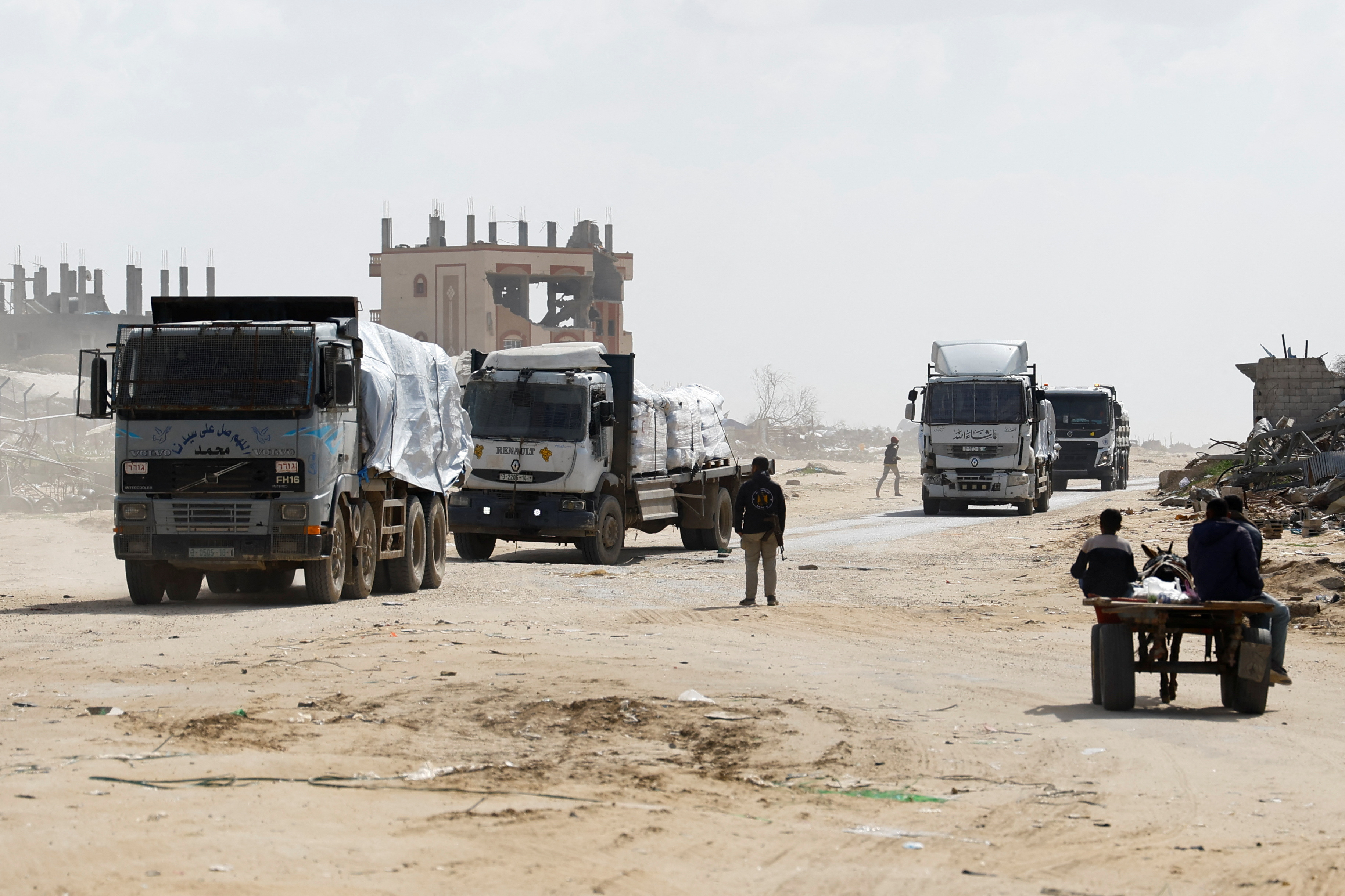 Trucks carrying aid drive, amid a ceasefire between Israel and Hamas, in Rafah