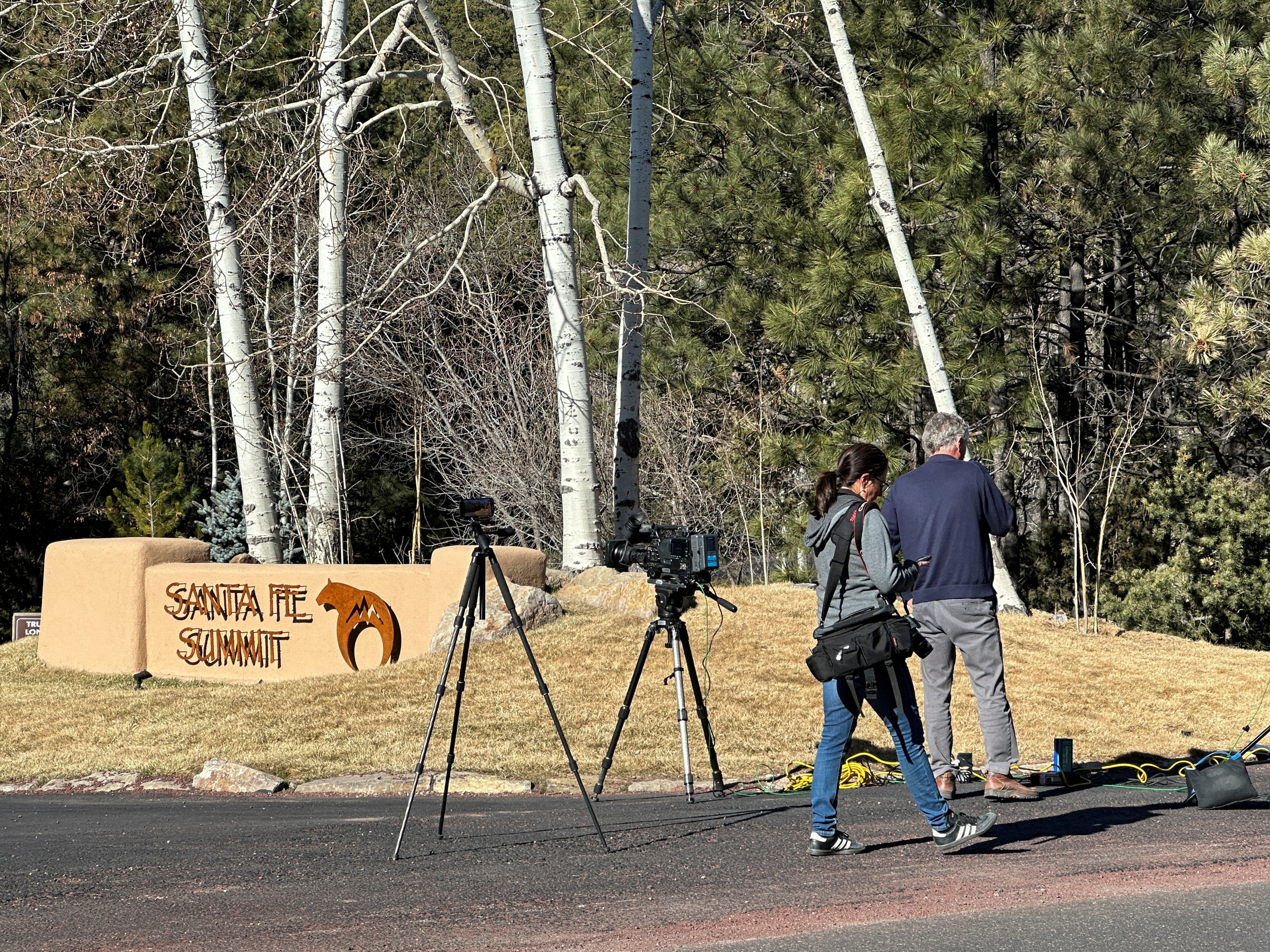 FILE PHOTO: Reporters gather outside the entrance to the gated community where actor Gene Hackman was found dead on Wednesday with his wife and dog, in Santa Fe