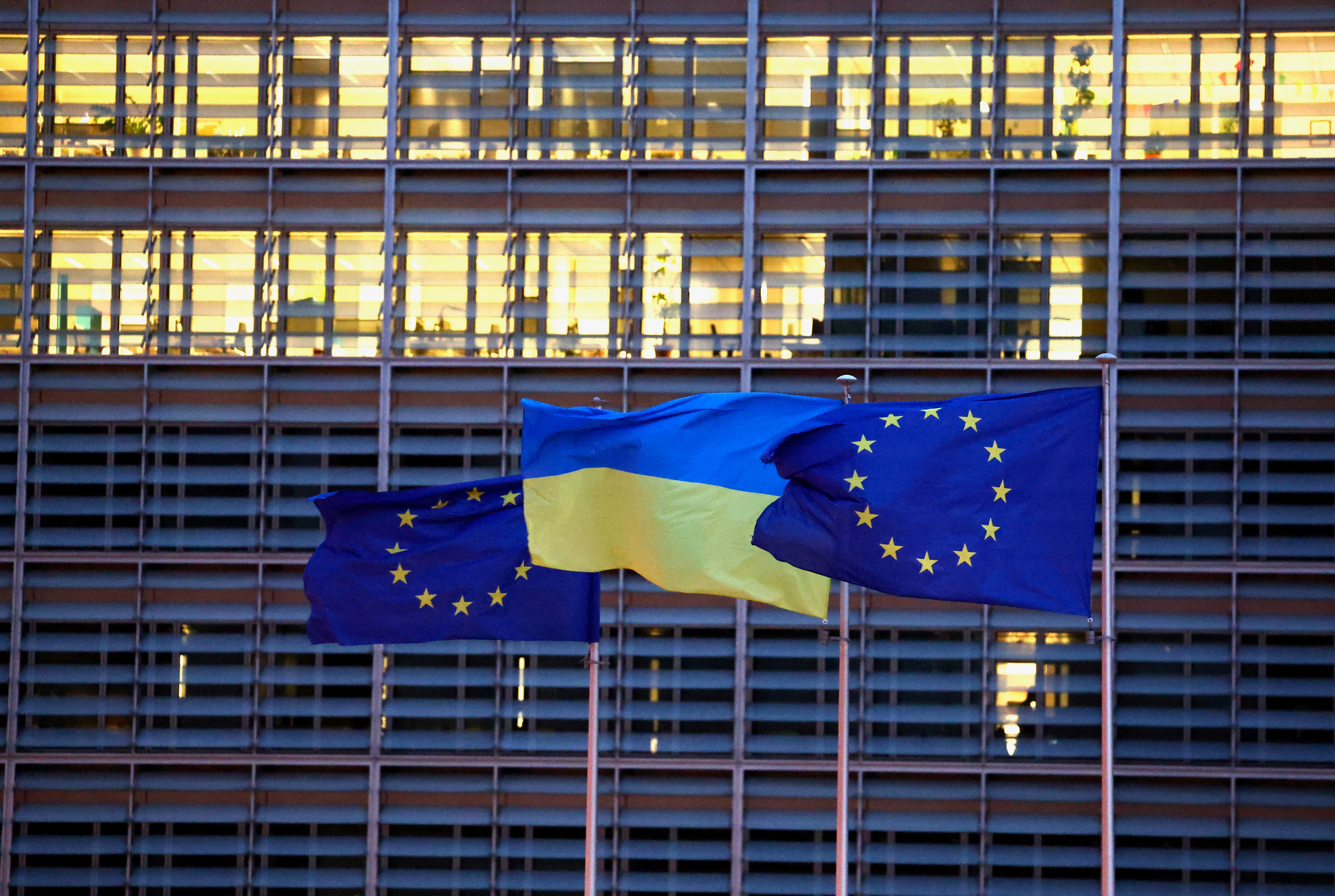 European Union flags and a Ukrainian flag flutter outside the EU Commission headquarters in Brussels