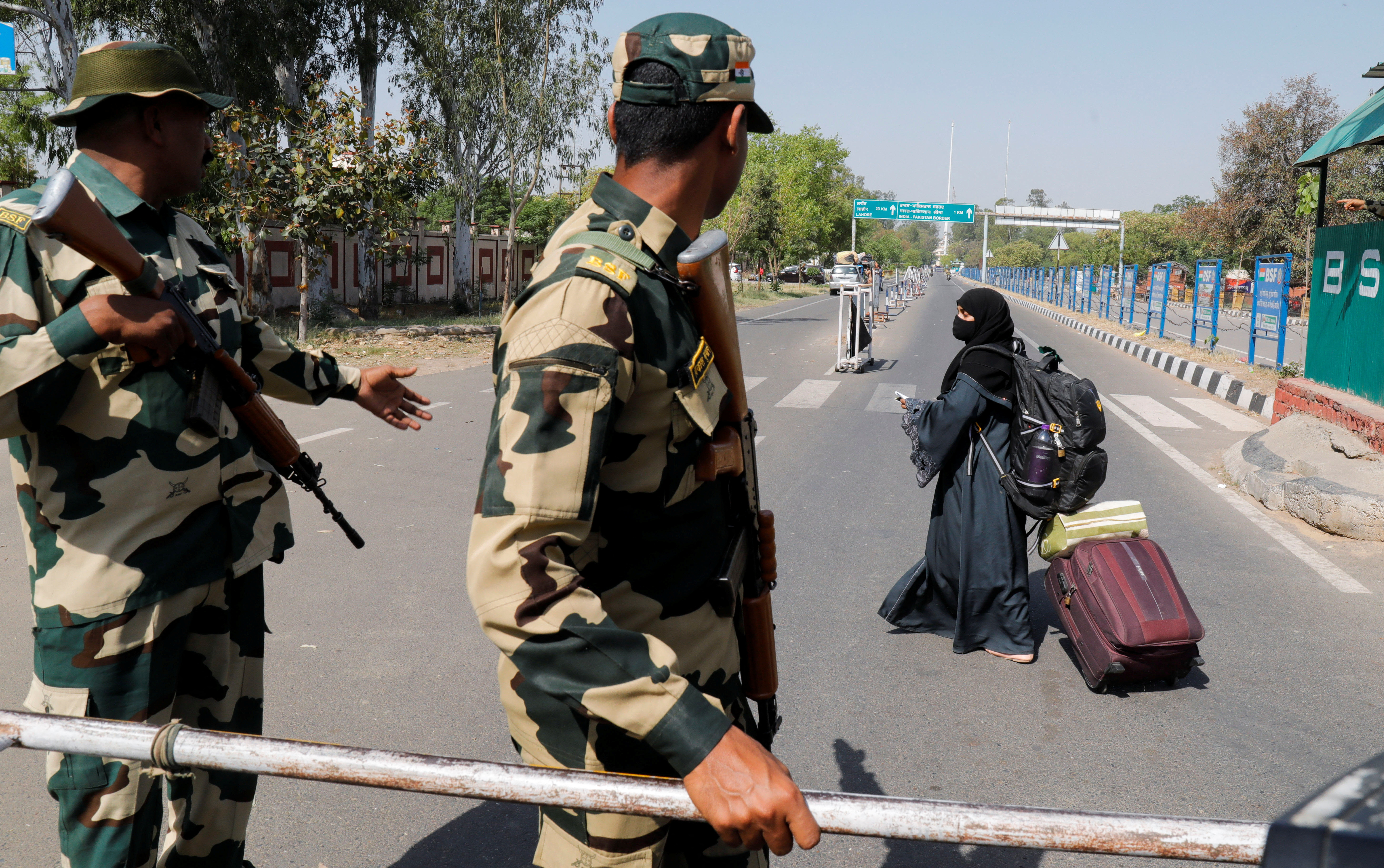 A woman crosses a Border Security Force (BSF) checkpoint at the Attari-Wagah crossing on the India-Pakistan border near Amritsar