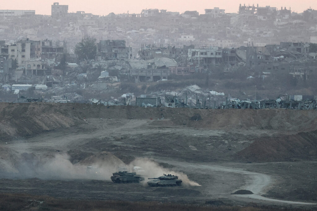 FILE PHOTO: Israeli tanks operate in Gaza, as seen from Israel