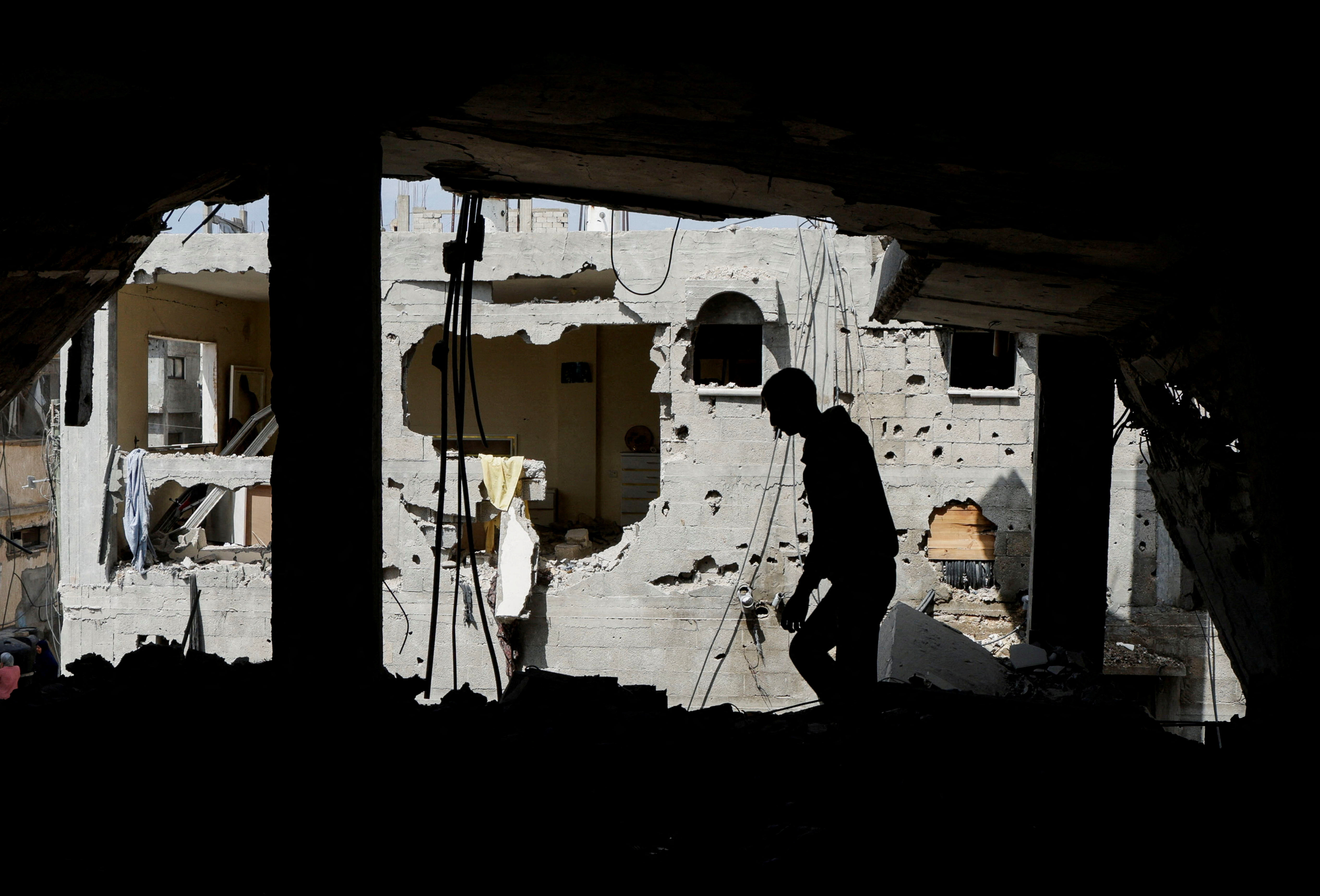 FILE PHOTO: Palestinian man inspects the house where Palestinian newlywed Hala Zaarab was killed in an Israeli airstrike, in Khan Younis