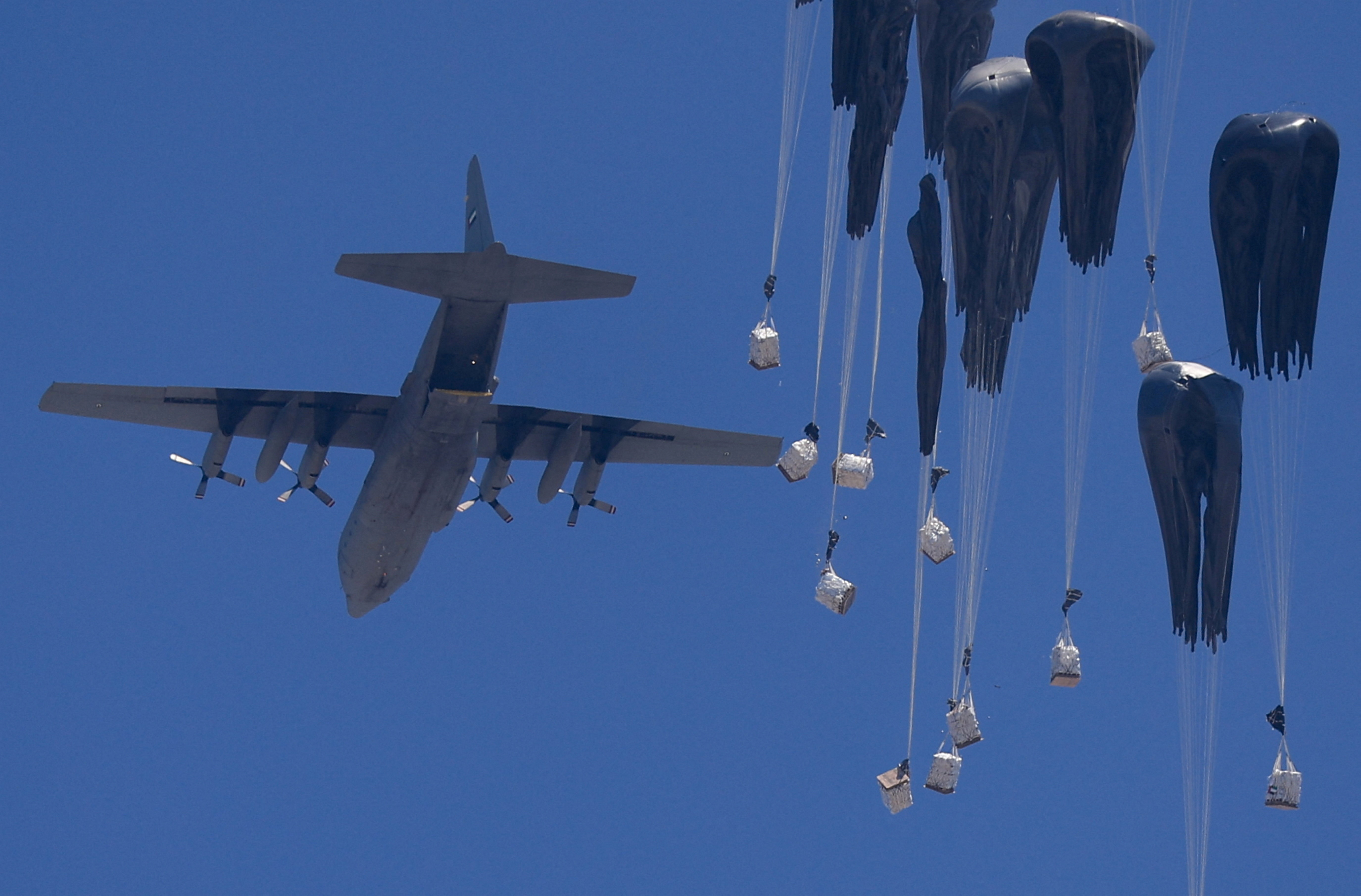 An airplane drops humanitarian aid over Gaza as seen from northern Gaza Strip July 27, 2025. REUTERS/Dawoud Abu Alkas