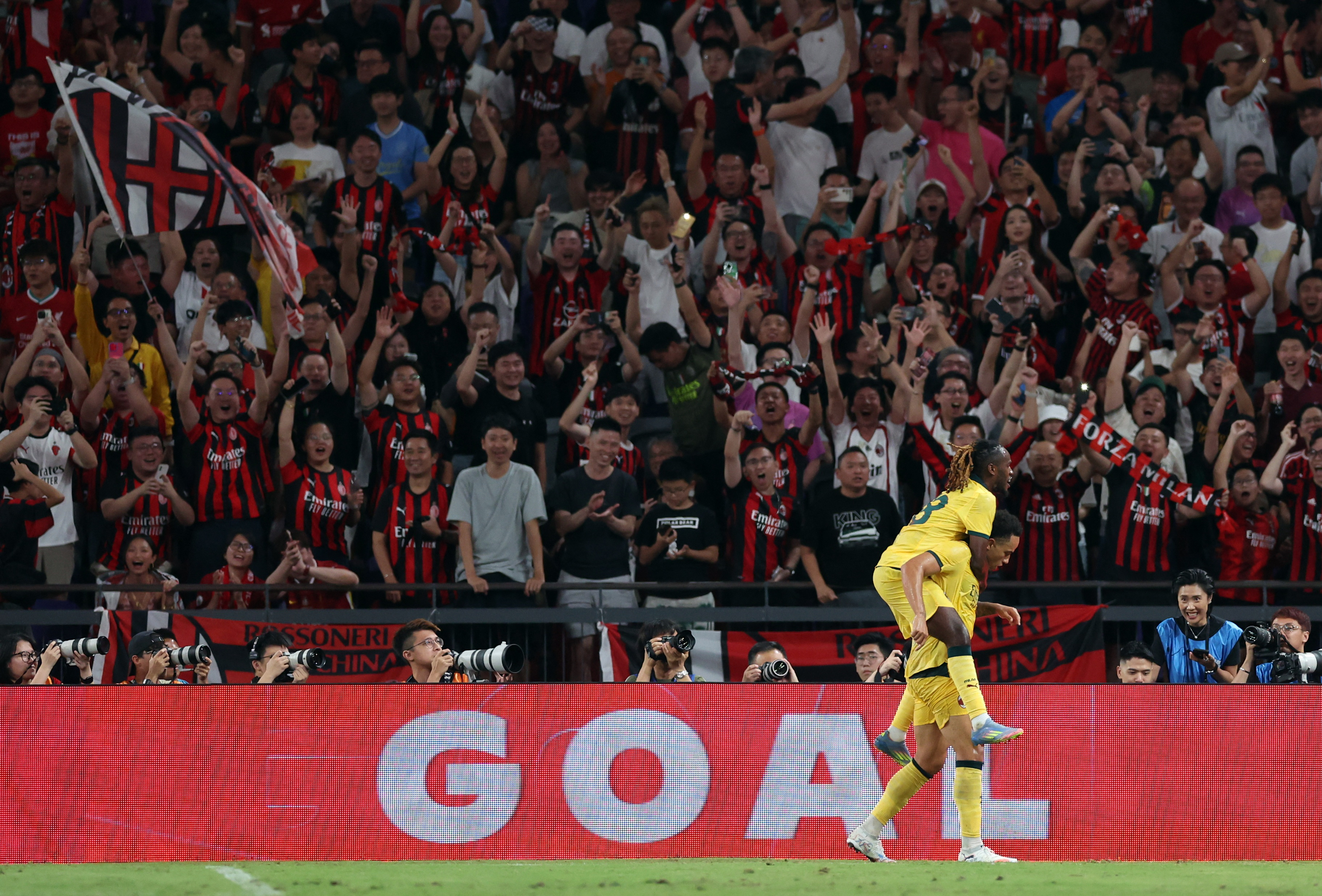 Soccer Football - Pre-Season Friendly - Liverpool v AC Milan - Kai Tak Sports Park, Hong Kong, China - July 26, 2025 AC Milan's Noah Okafor celebrates scoring their fourth goal with Warren Bondo REUTERS/Tyrone Siu