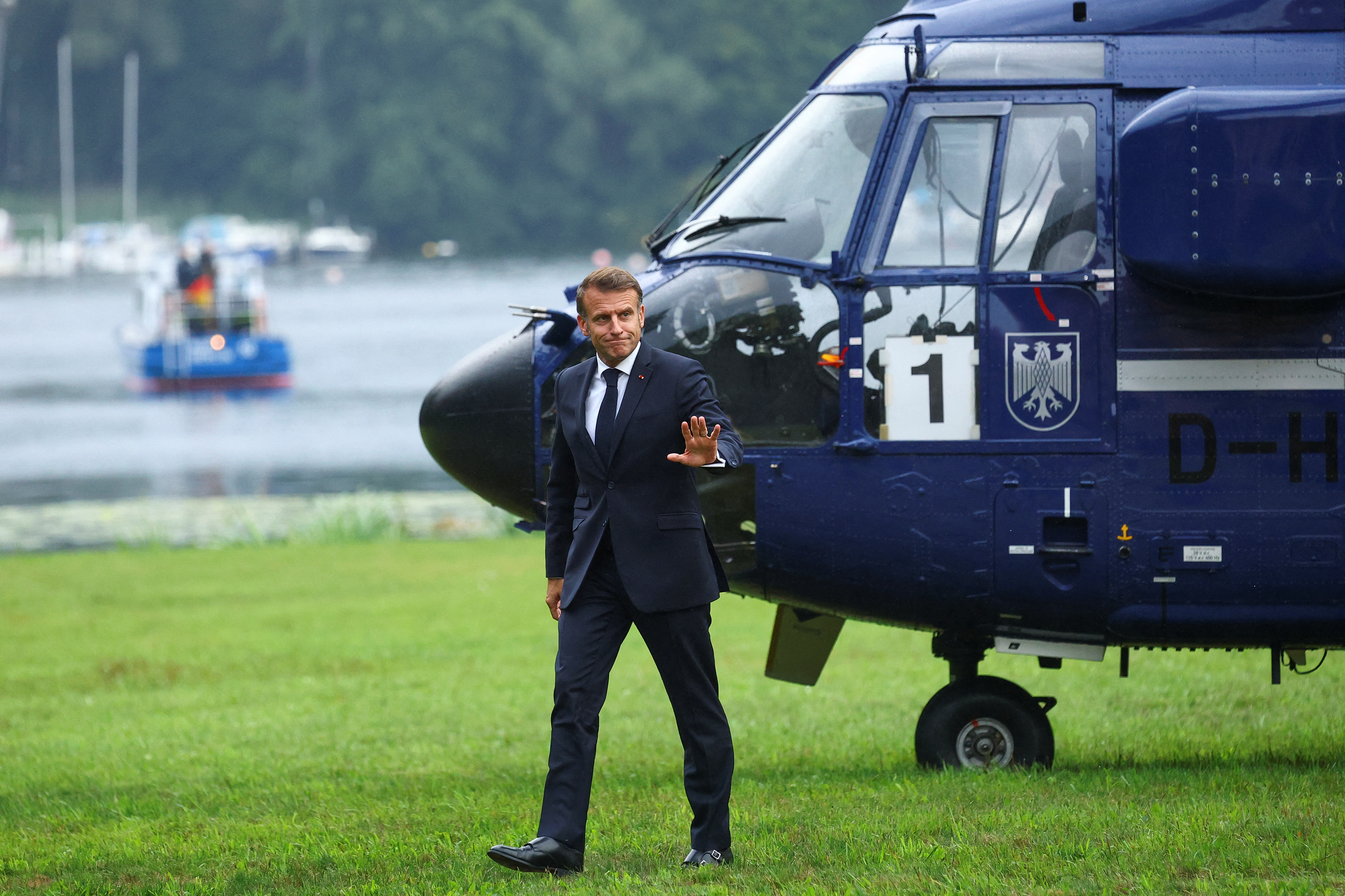 French President Emmanuel Macron disembarks from a helicopter ahead of bilateral talks with German Chancellor Friedrich Merz at Villa Borsig in Berlin, Germany, July 23, 2025. REUTERS/Lisi Niesner
