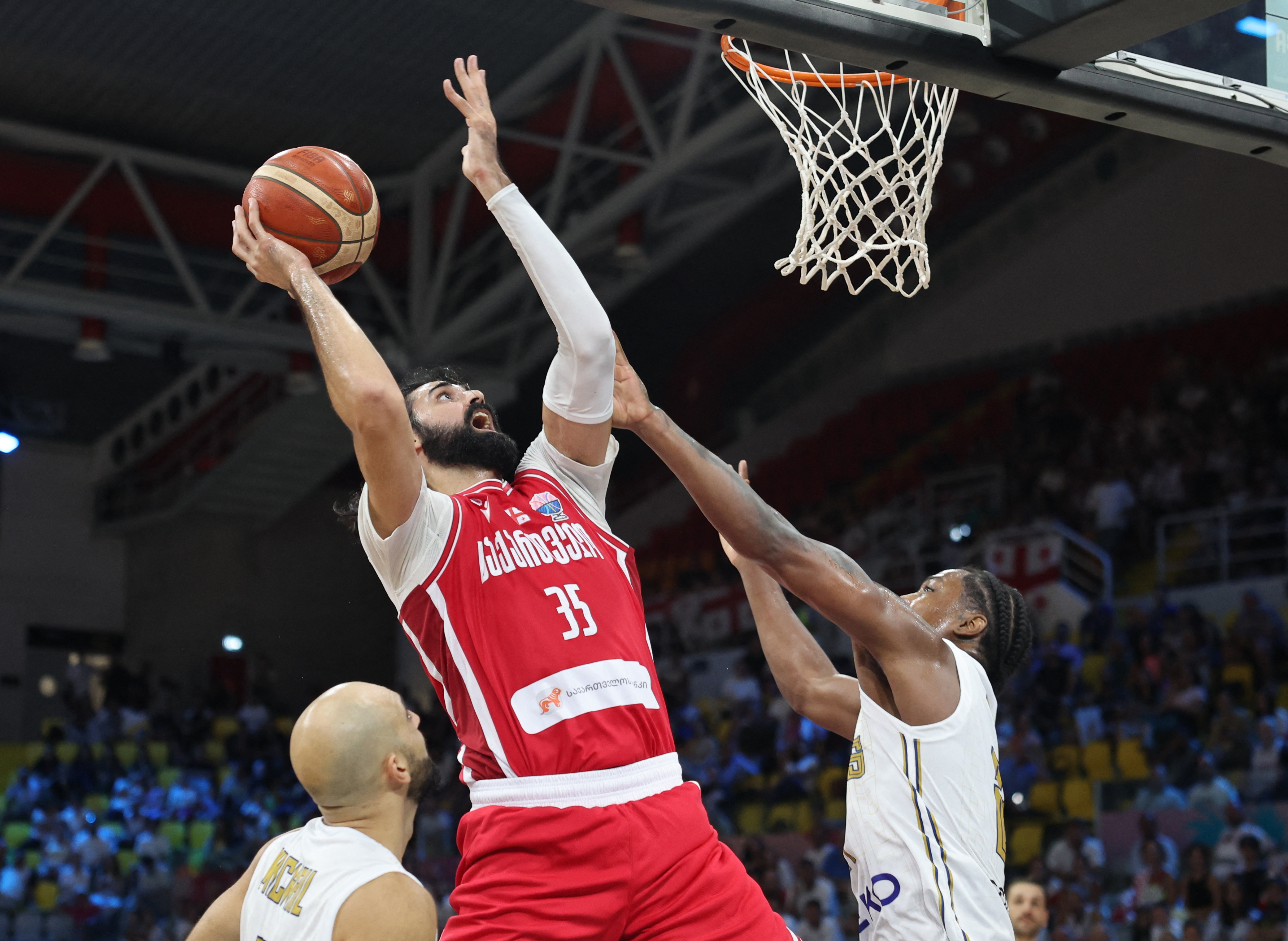 Basketball - FIBA EuroBasket 2025 - Group Phase - Cyprus v Georgia - Spyros Kyprianou Athletic Center, Limassol, Cyprus - September 2, 2025 Georgia's Goga Bitadze in action with Cyprus' Darral Willis Jr REUTERS/Yiannis Kourtoglou