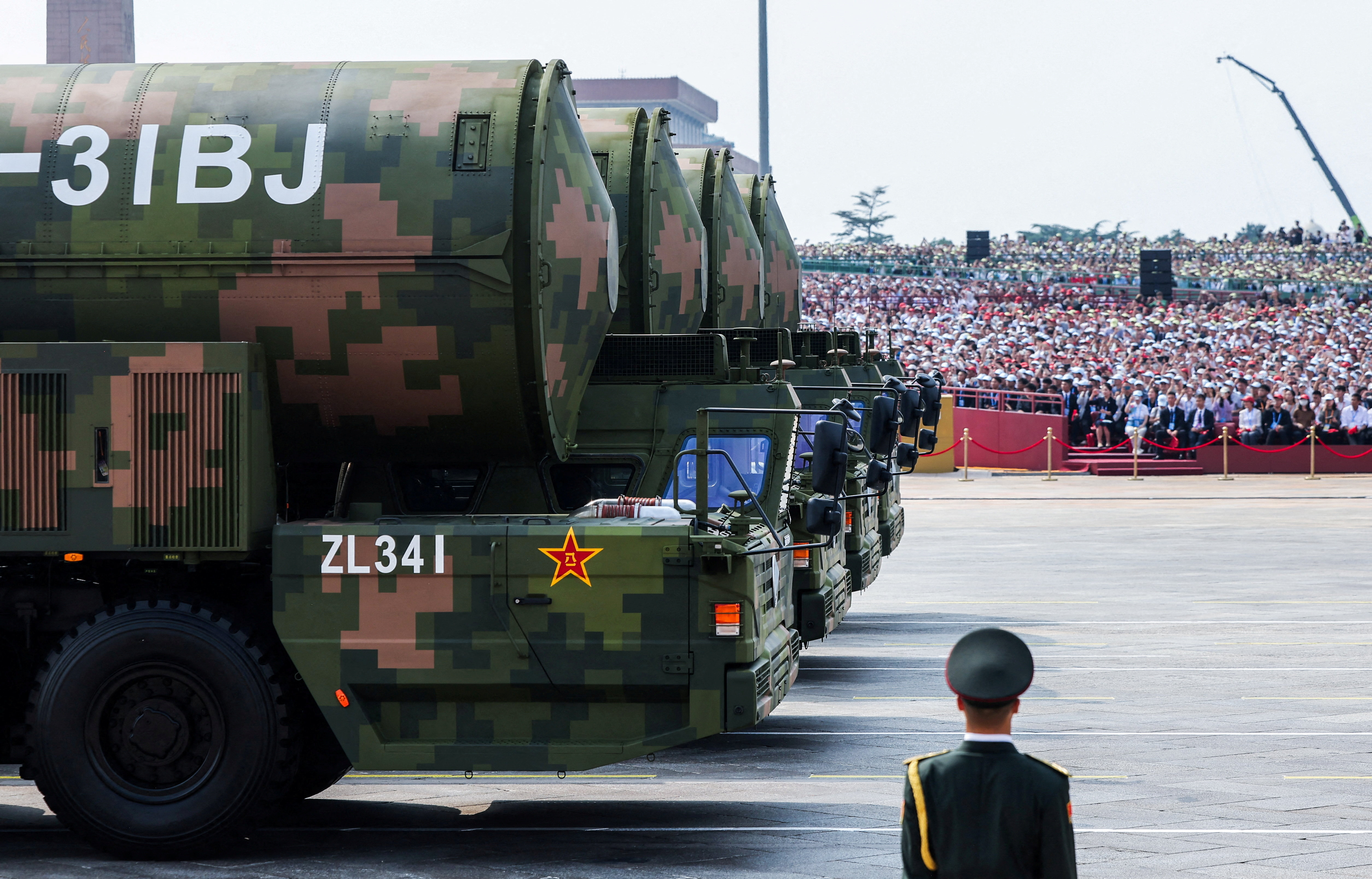 A member of the People's Liberation Army stands as the strategic strike group displays DF-31BJ nuclear missiles during a military parade to mark the 80th anniversary of the end of World War Two, in Beijing, China, September 3, 2025. REUTERS/Maxim Shemetov