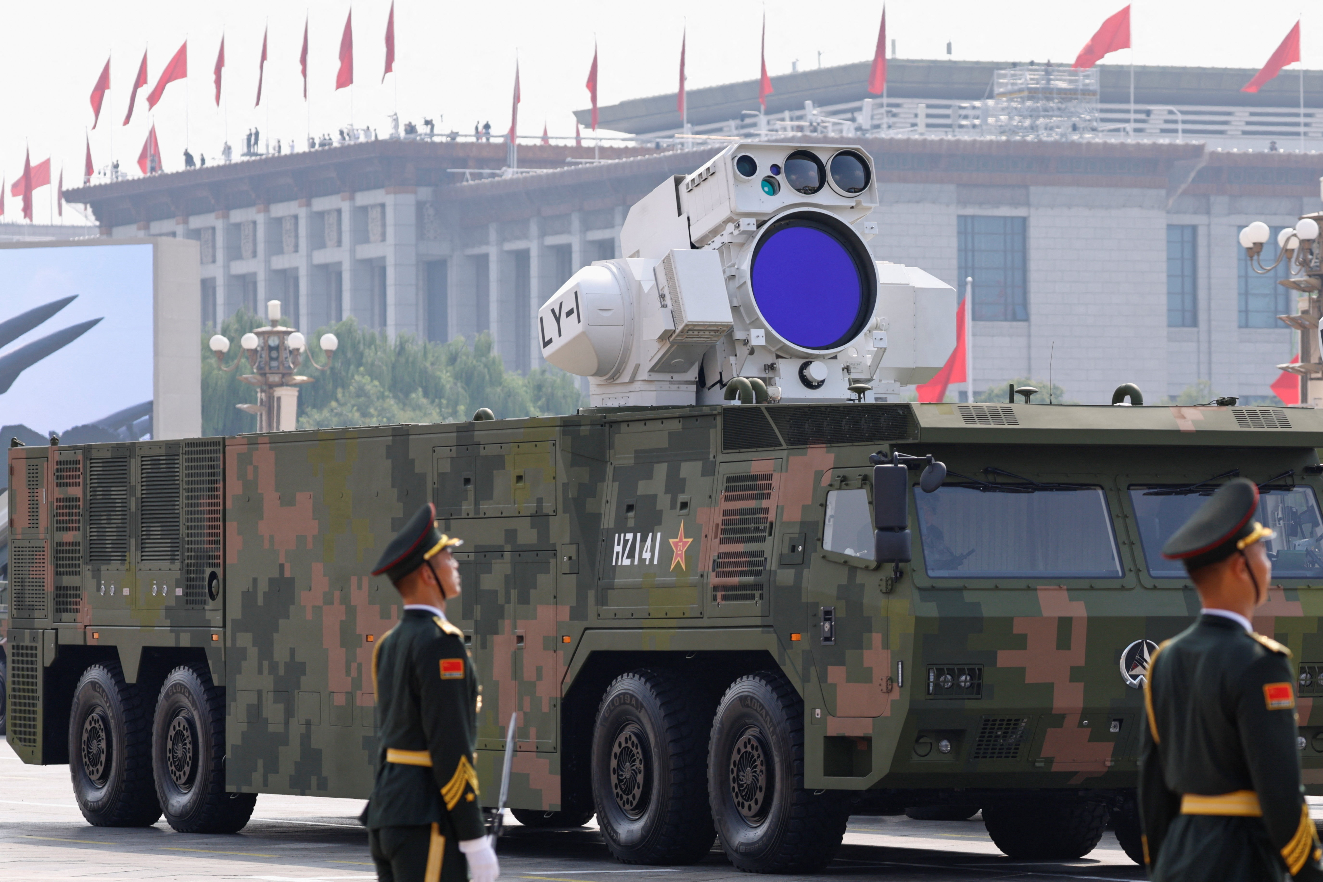 Members of the People's Liberation Army stand as air-defense laser weapon is displayed during a military parade to mark the 80th anniversary of the end of World War Two, in Beijing, China, September 3, 2025. REUTERS/Tingshu Wang