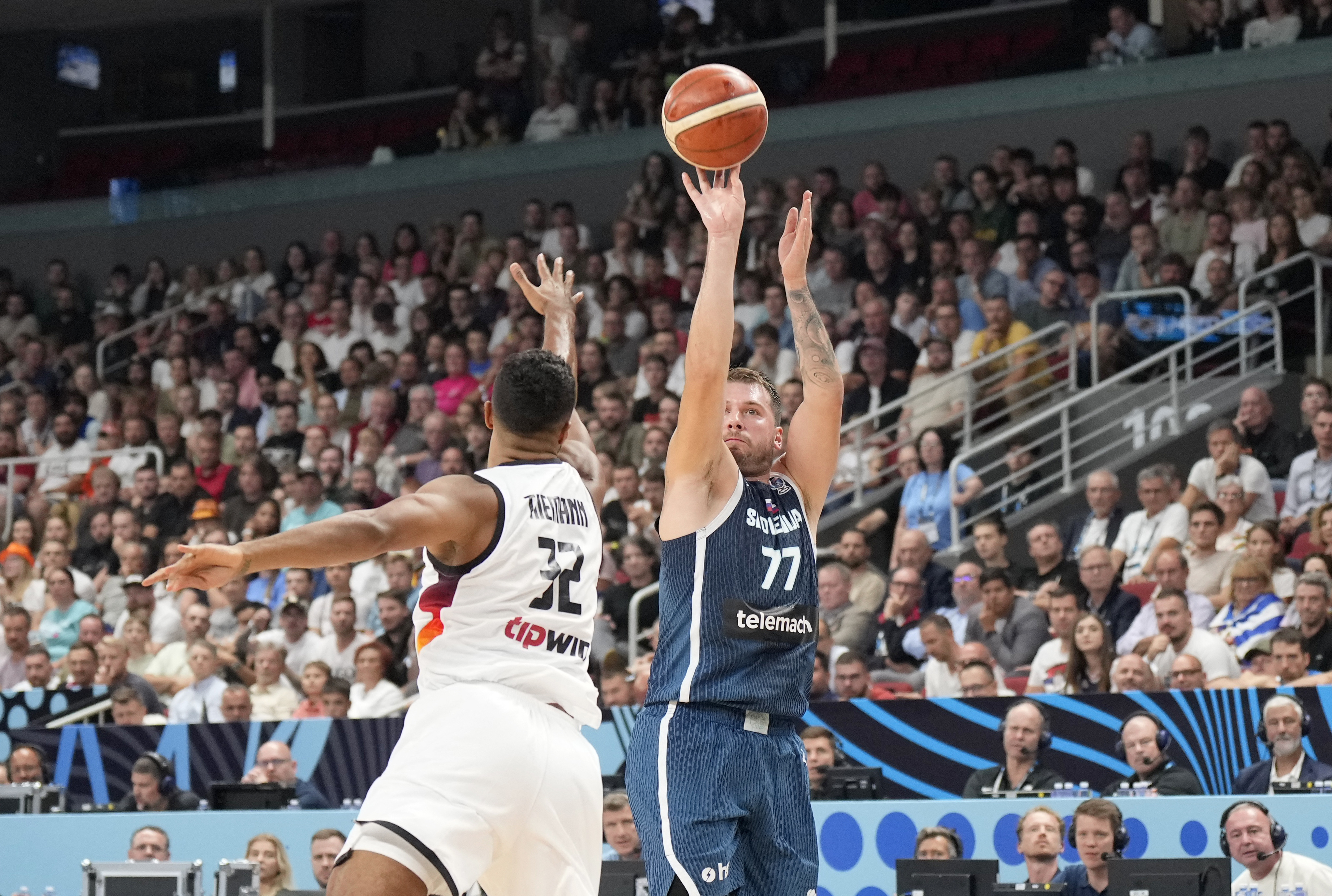 Basketball - FIBA EuroBasket 2025 - Quarter Finals - Germany v Slovenia - Xiaomi Arena, Riga, Latvia - September 10, 2025 Slovenia's Luka Doncic in action with Germany's Johannes Thiemann REUTERS/Ints Kalnins
