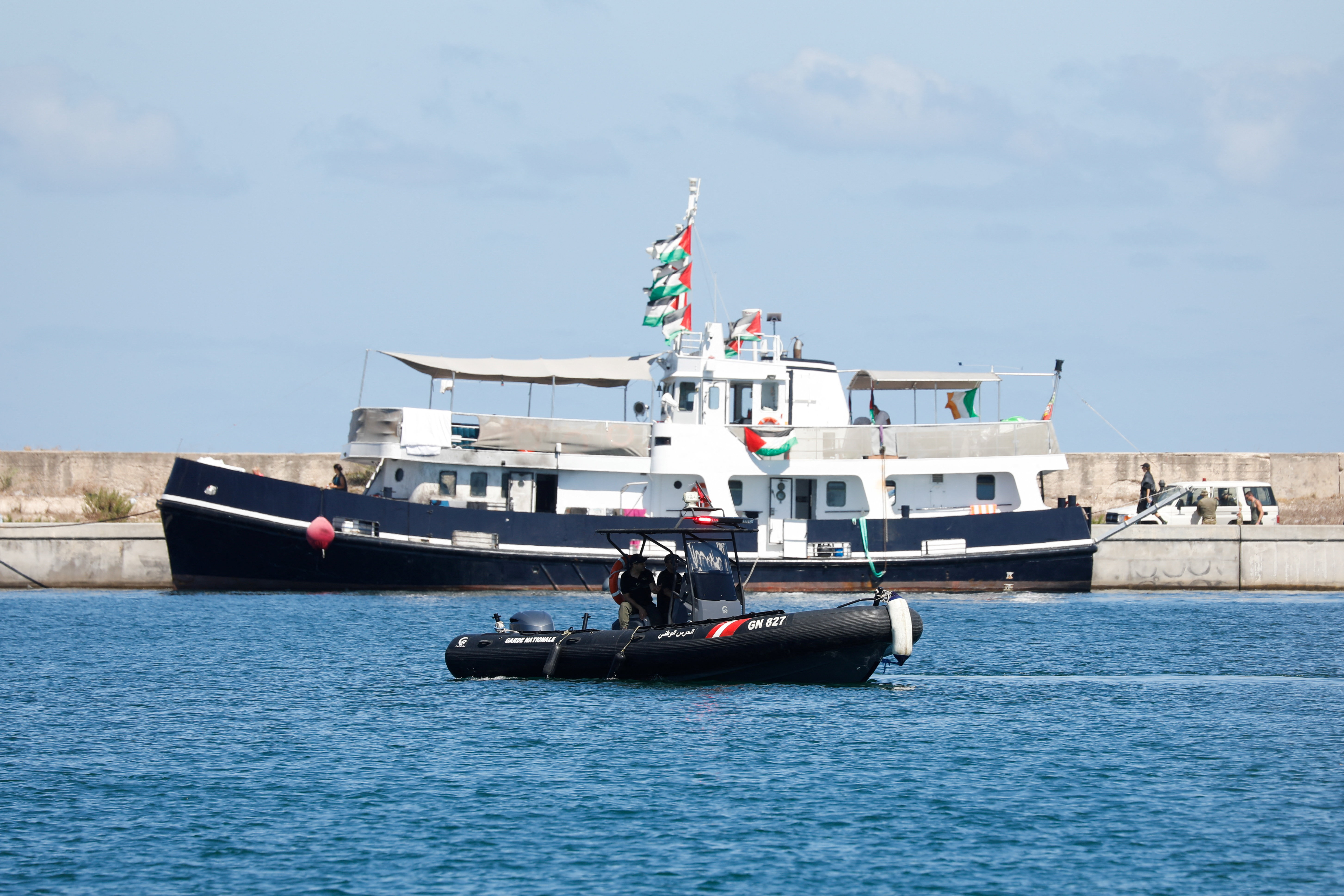 A maritime guard patrol boat sails, as participants of the Global Sumud Flotilla