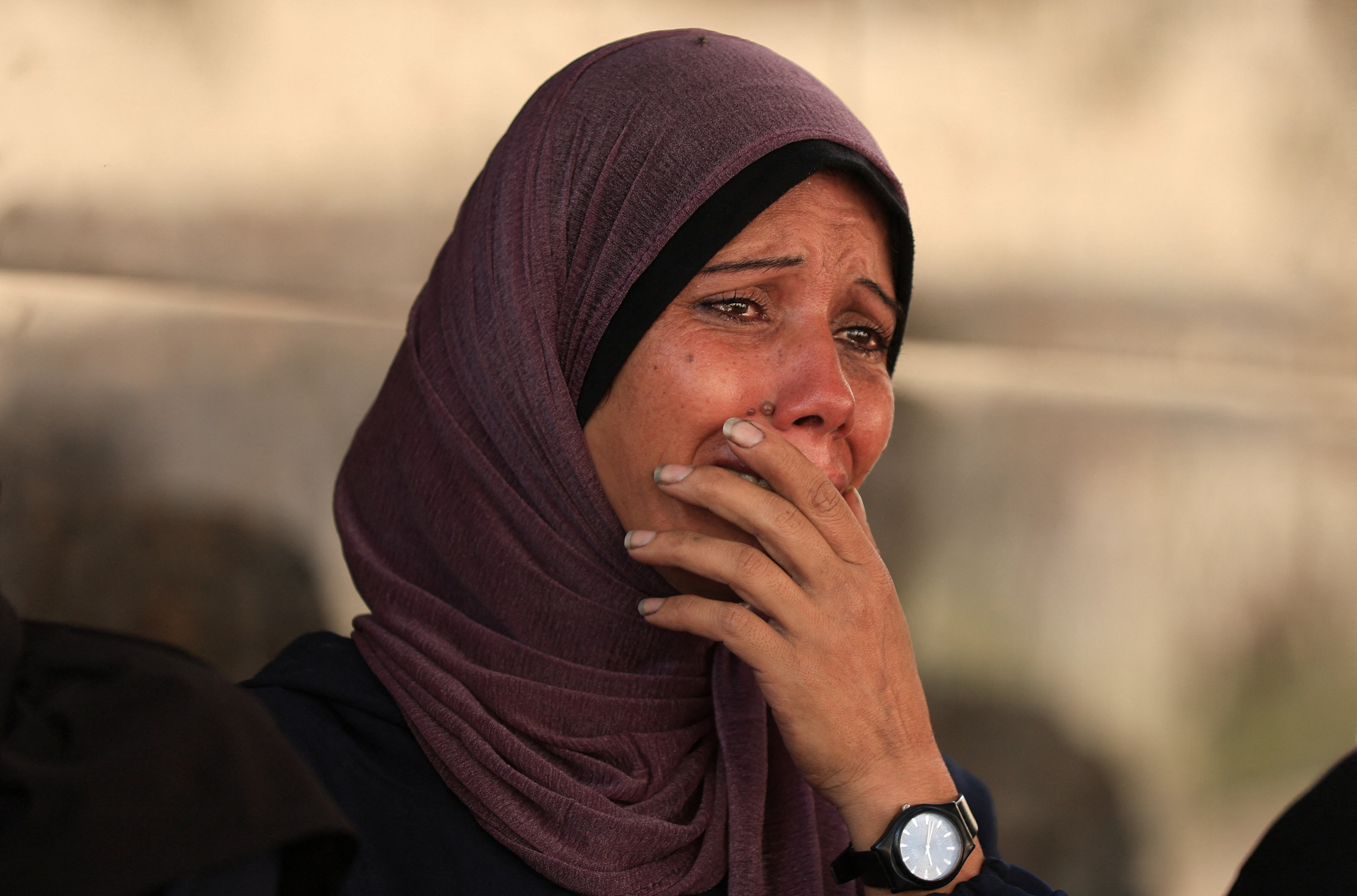 A mourner reacts during the funeral of Palestinians killed in overnight Israeli strikes