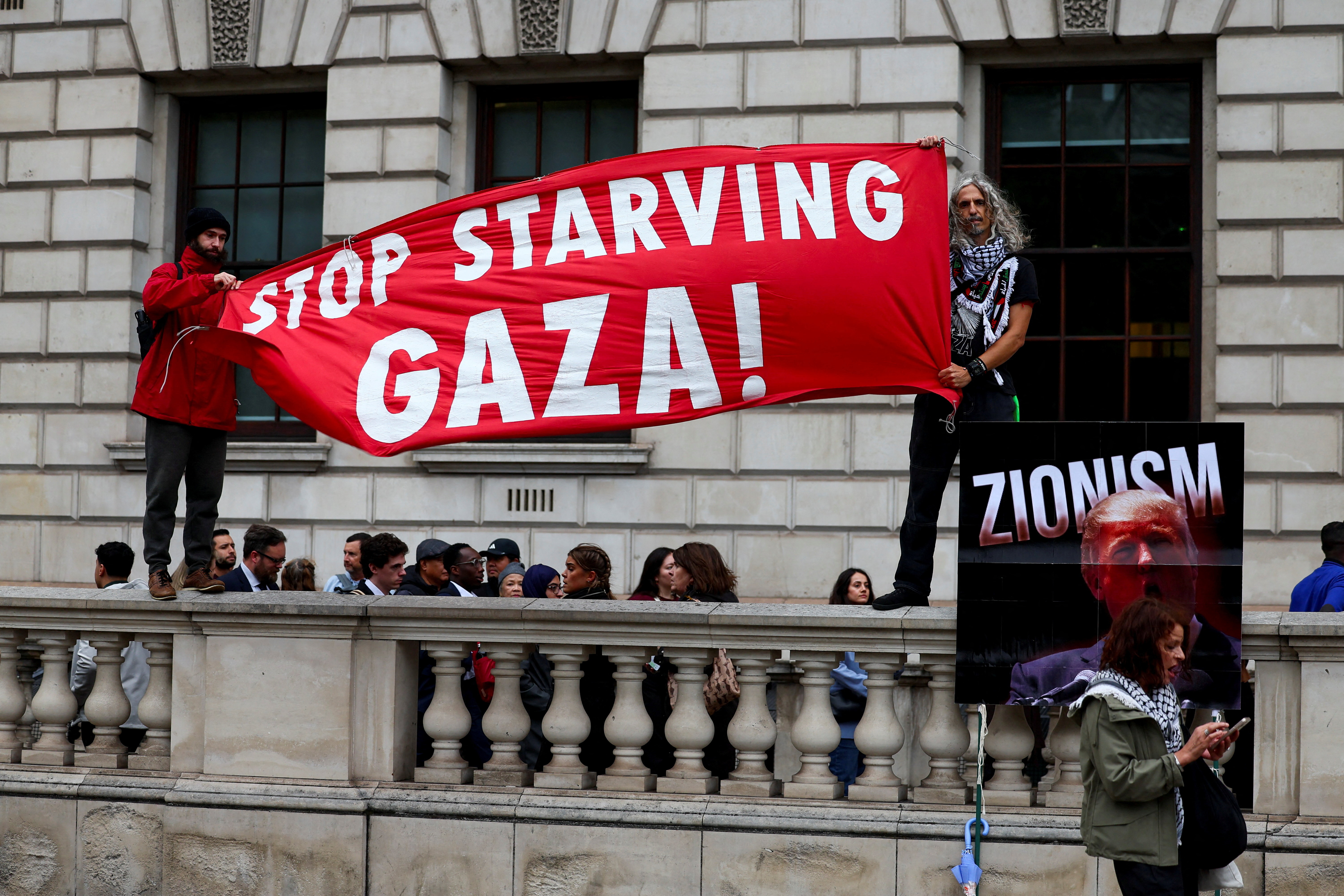 Demonstrators hold a banner at a 'Trump Not Welcome' protest during the state visit of U.S. President Donald Trump and first lady Melania Trump, in London, Britain, September 17, 2025. REUTERS/Isabel Infantes      TPX IMAGES OF THE DAY