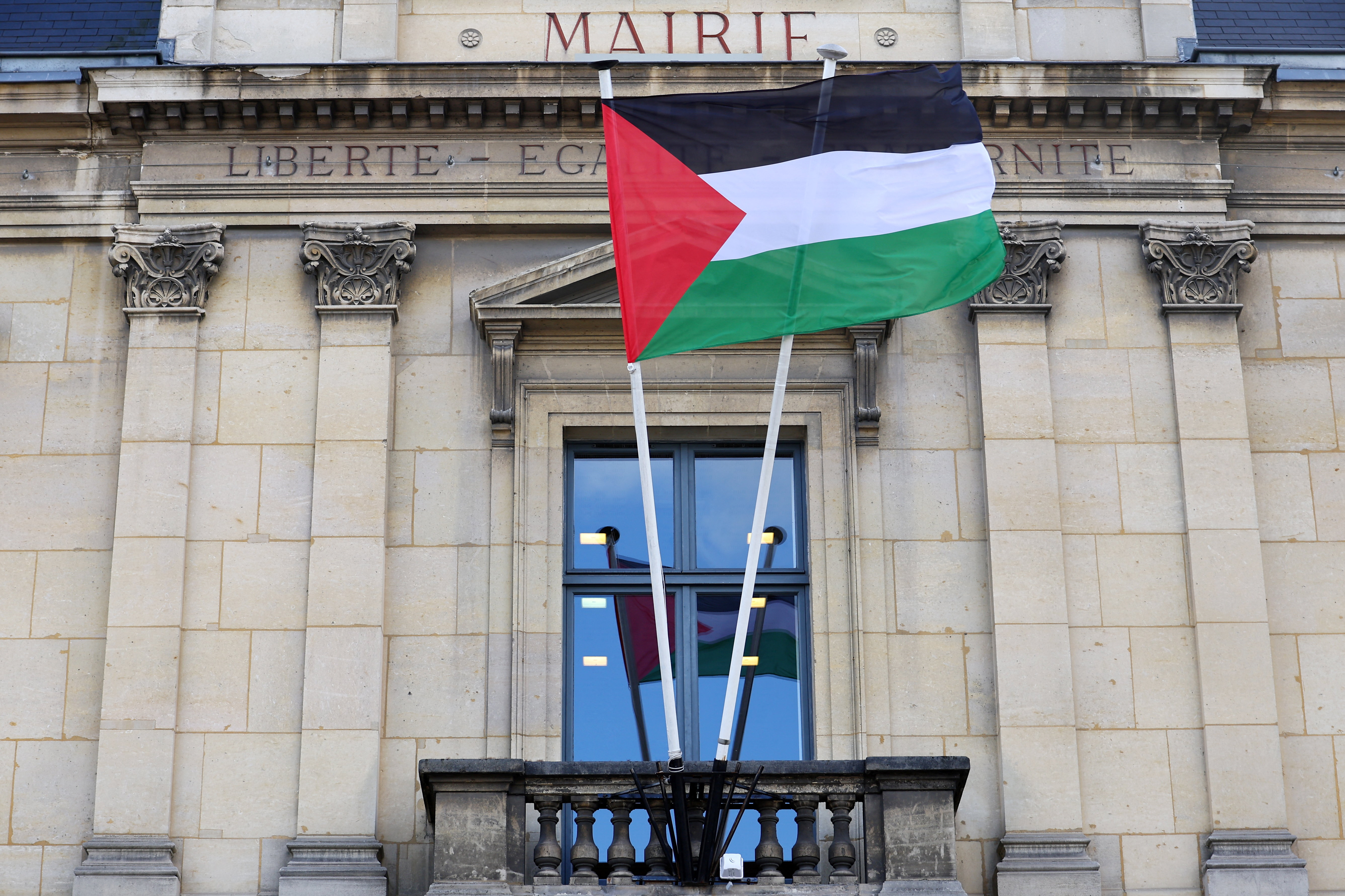 The Palestinian flag flies on the facade of the city hall in Saint-Ouen near Paris