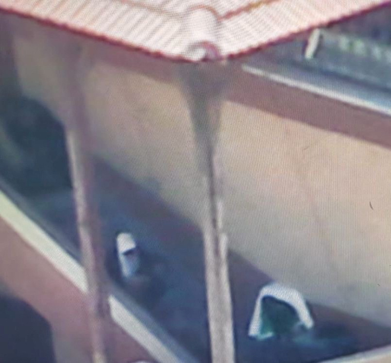 A still frame from drone video, obtained by Israeli citizen Refael Hayun, shows a covered camera and a person sitting on Nasser Hospital's eastern stairwell in Khan Younis, in Gaza. Refael Hayun/via REUTERS.