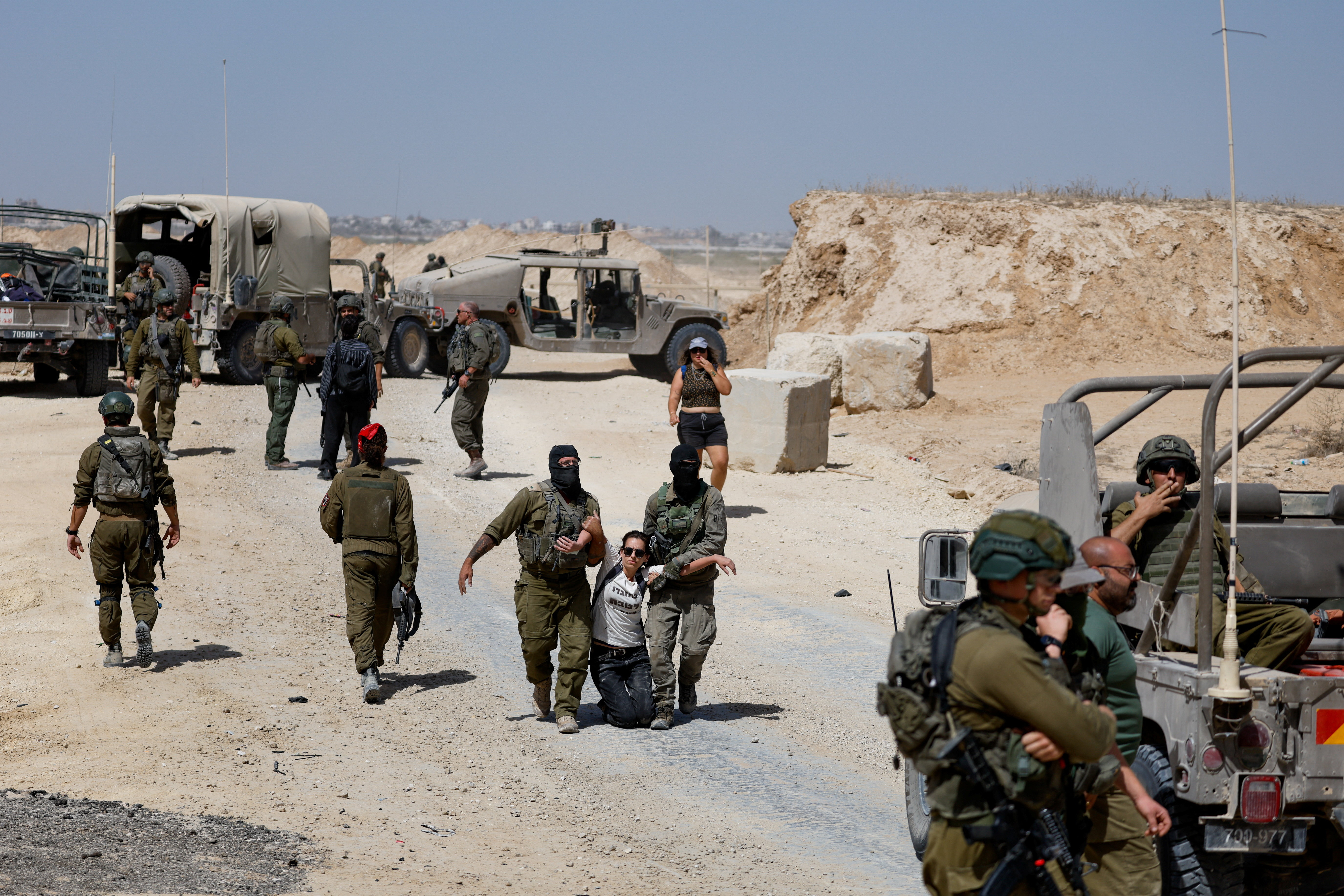 A demonstrator is detained during a protest against Israel's interception of the Global Sumud Flotilla which was carrying aid for Gaza, on the border in southern Israel, October 3, 2025. REUTERS/Amir Cohen