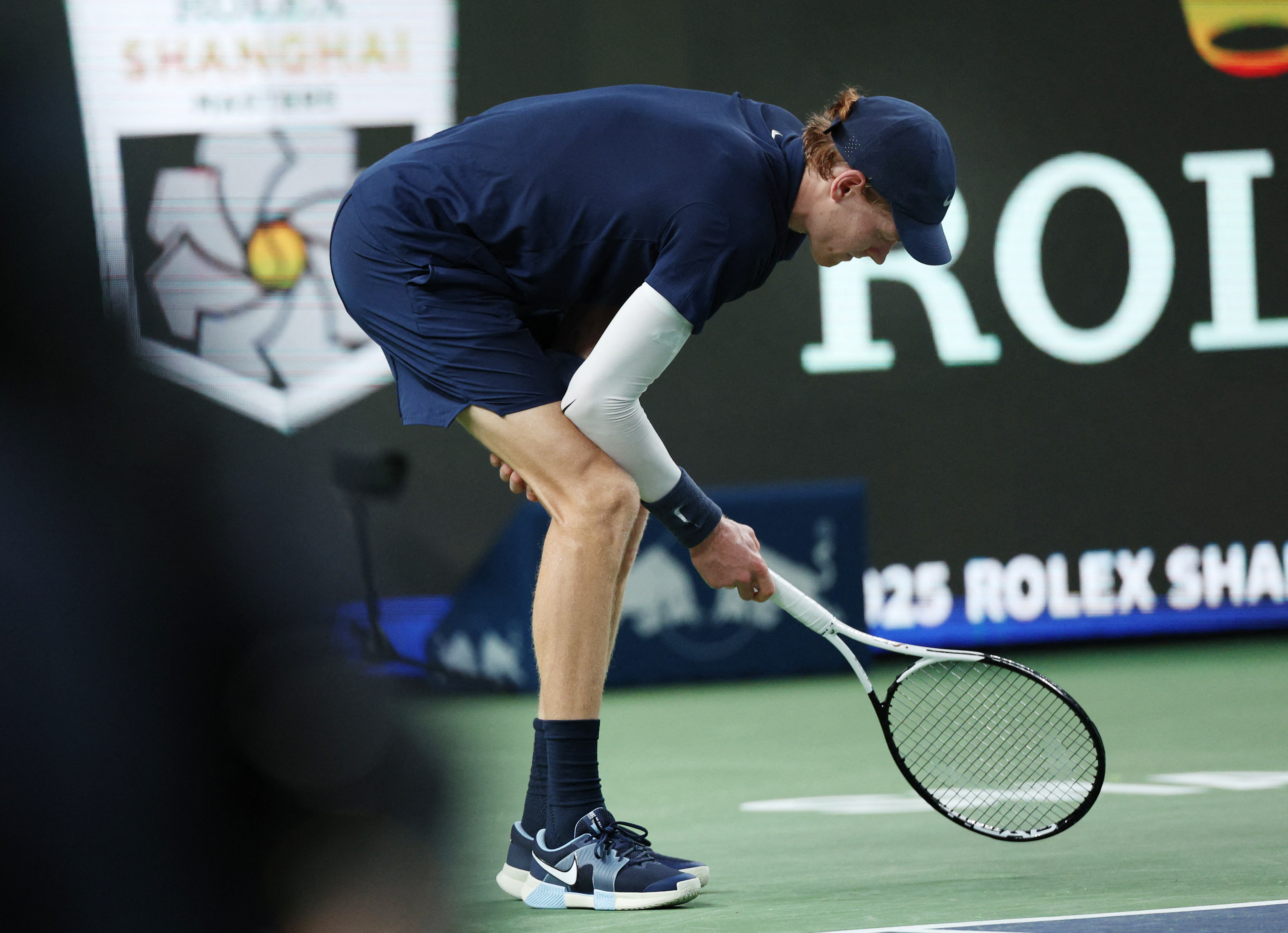 Tennis - ATP Masters 1000 - Shanghai Masters - Qizhong Forest Sports City Arena, Shanghai, China - October 5, 2025 Italy's Jannik Sinner reacts before retiring from his round of 32 match against Netherlands' Tallon Griekspoor REUTERS/Go Nakamura