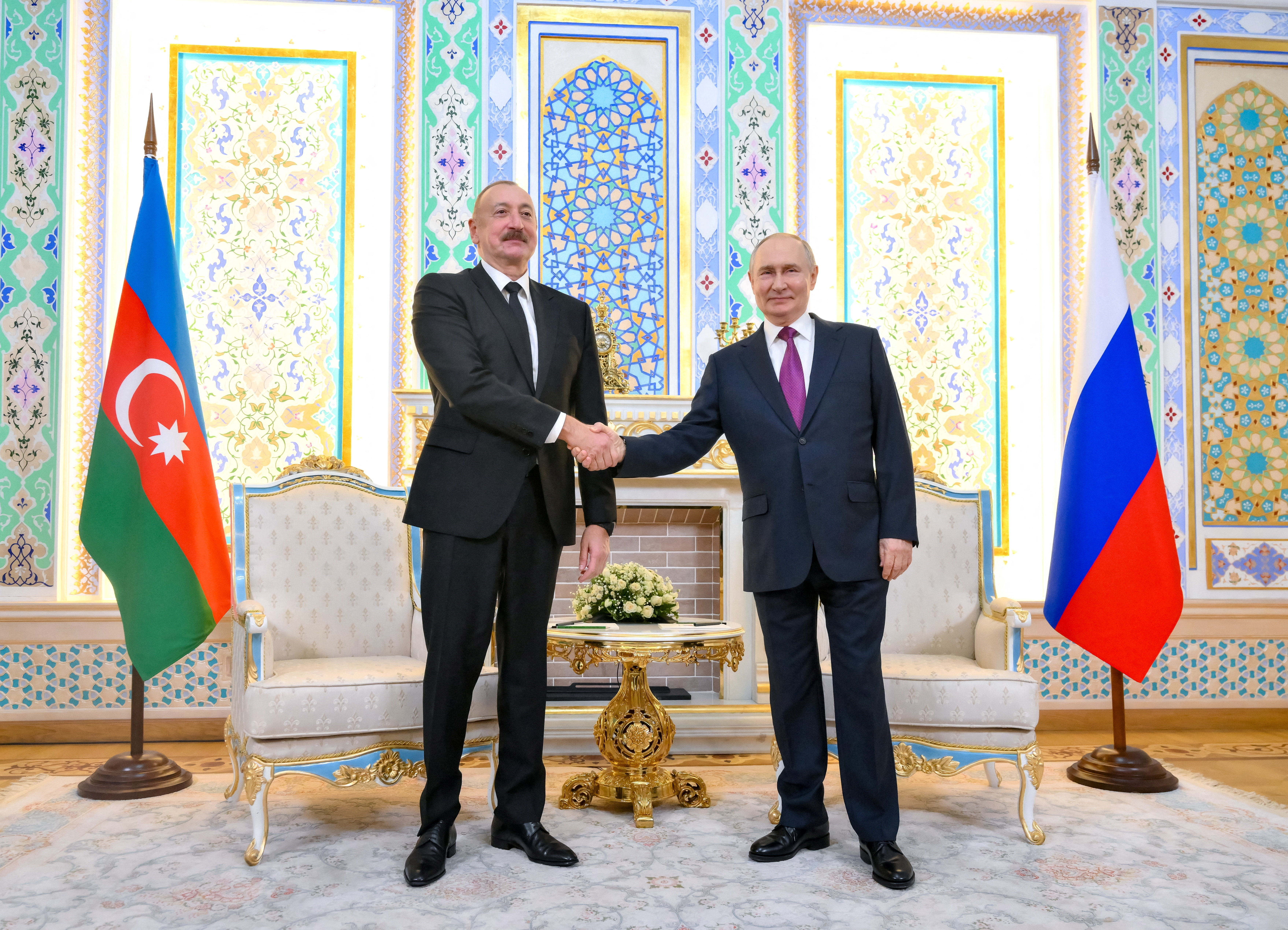 Russian President Vladimir Putin shakes hands with Azerbaijani President Ilham Aliyev