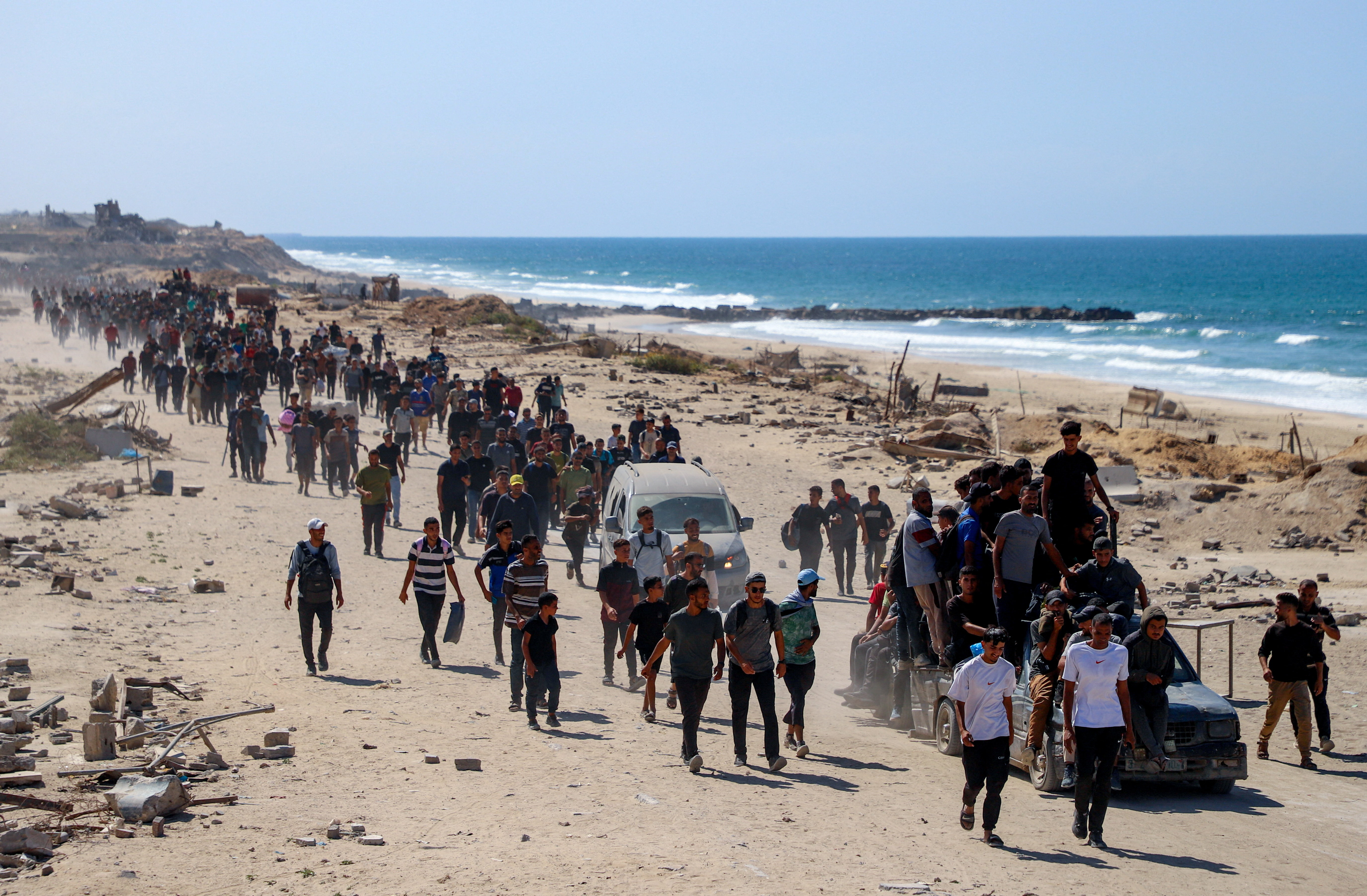 Palestinians, who were displaced to the southern part of Gaza at Israel's order during the war, make their way following their arrival in Gaza City after a ceasefire