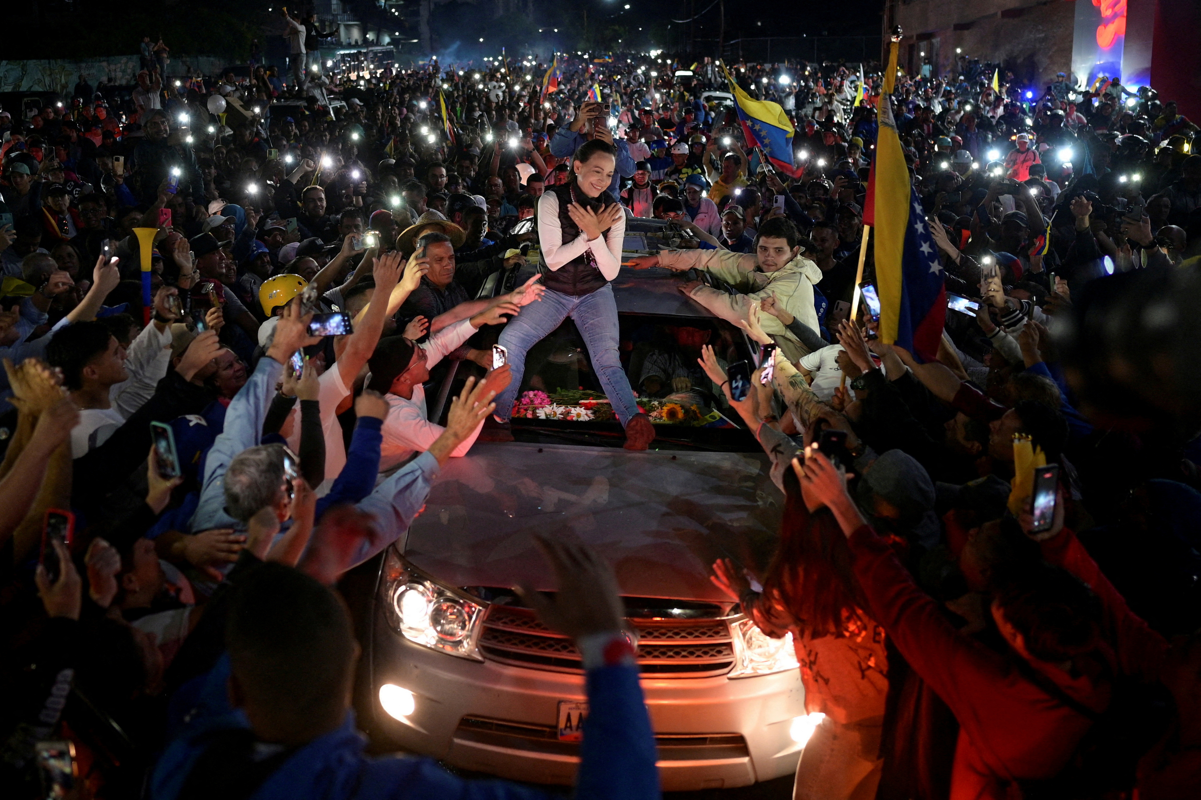 FILE PHOTO: Venezuelan opposition leader Maria Corina Machado greets supporters