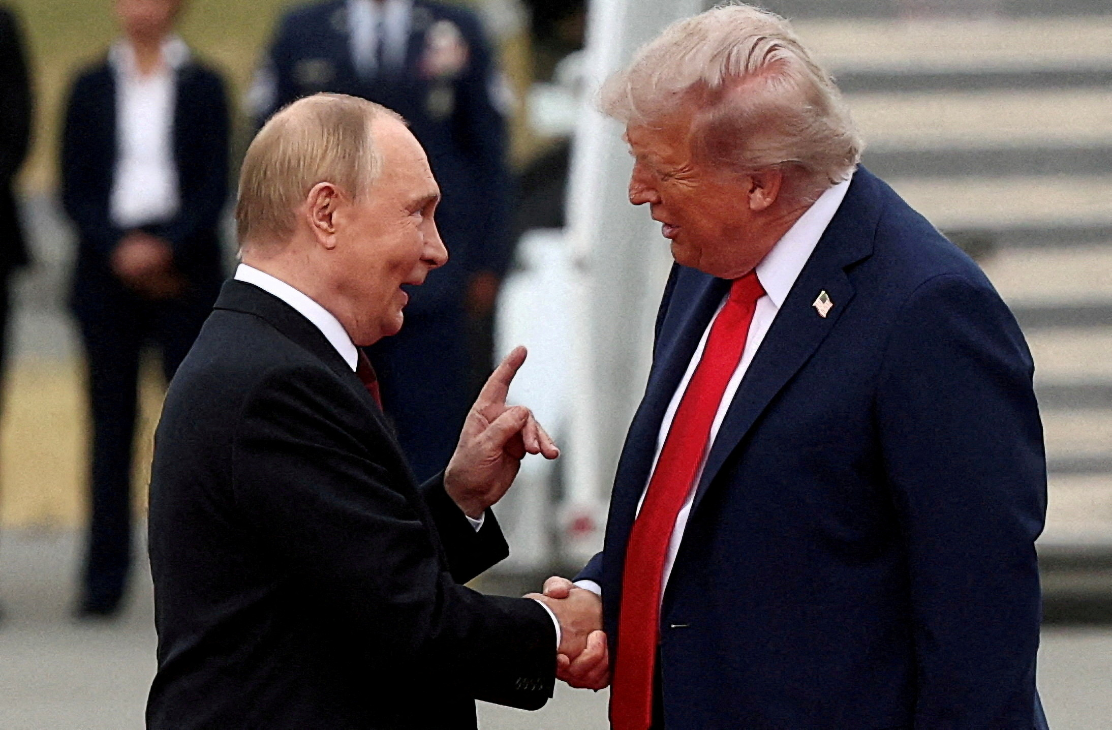 FILE PHOTO: U.S. President Donald Trump shakes hand with Russian President