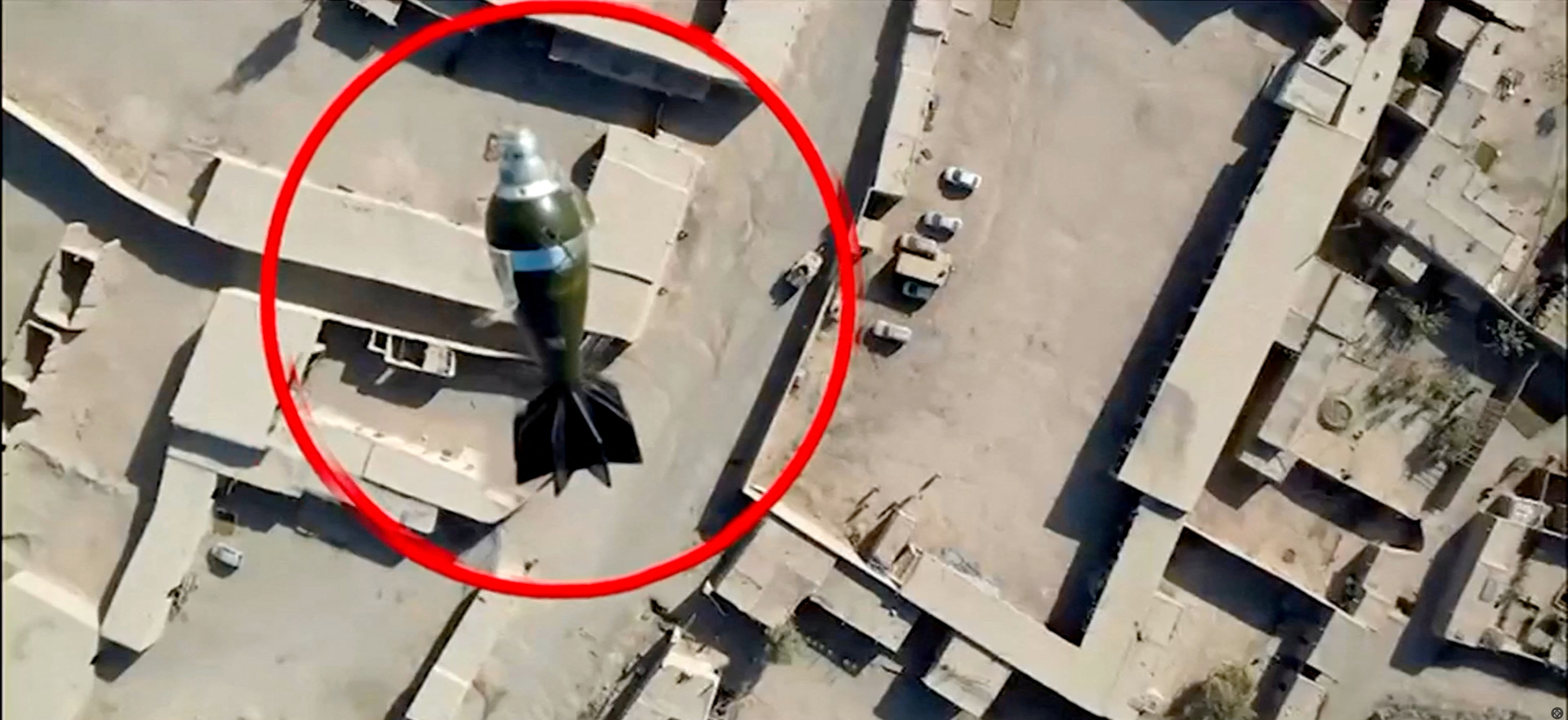 A mortar round falls towards a target from a drone