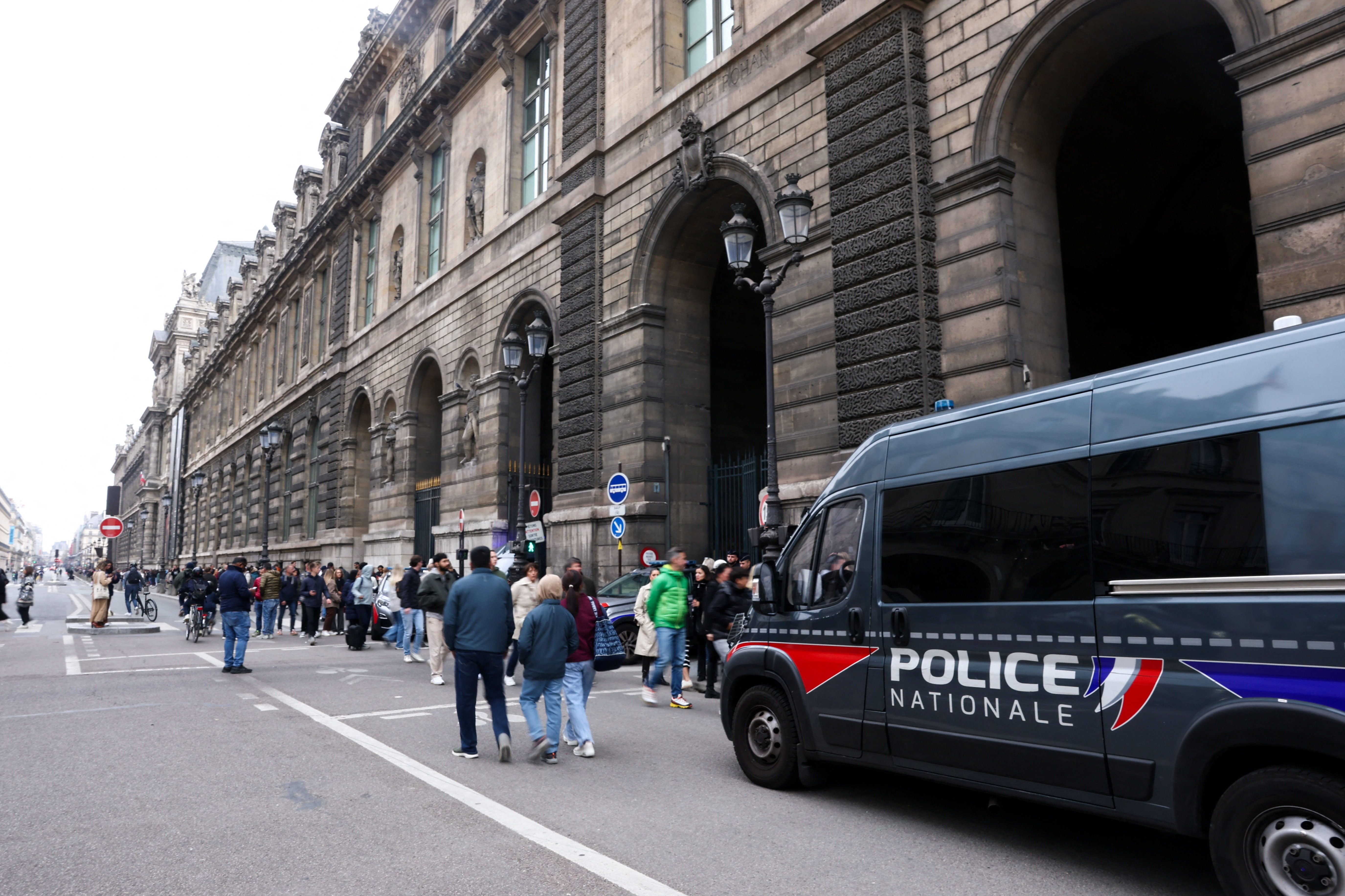 Police vehicle stands near the entrance to the Louvre museum after reports of a robbery, in Paris, France