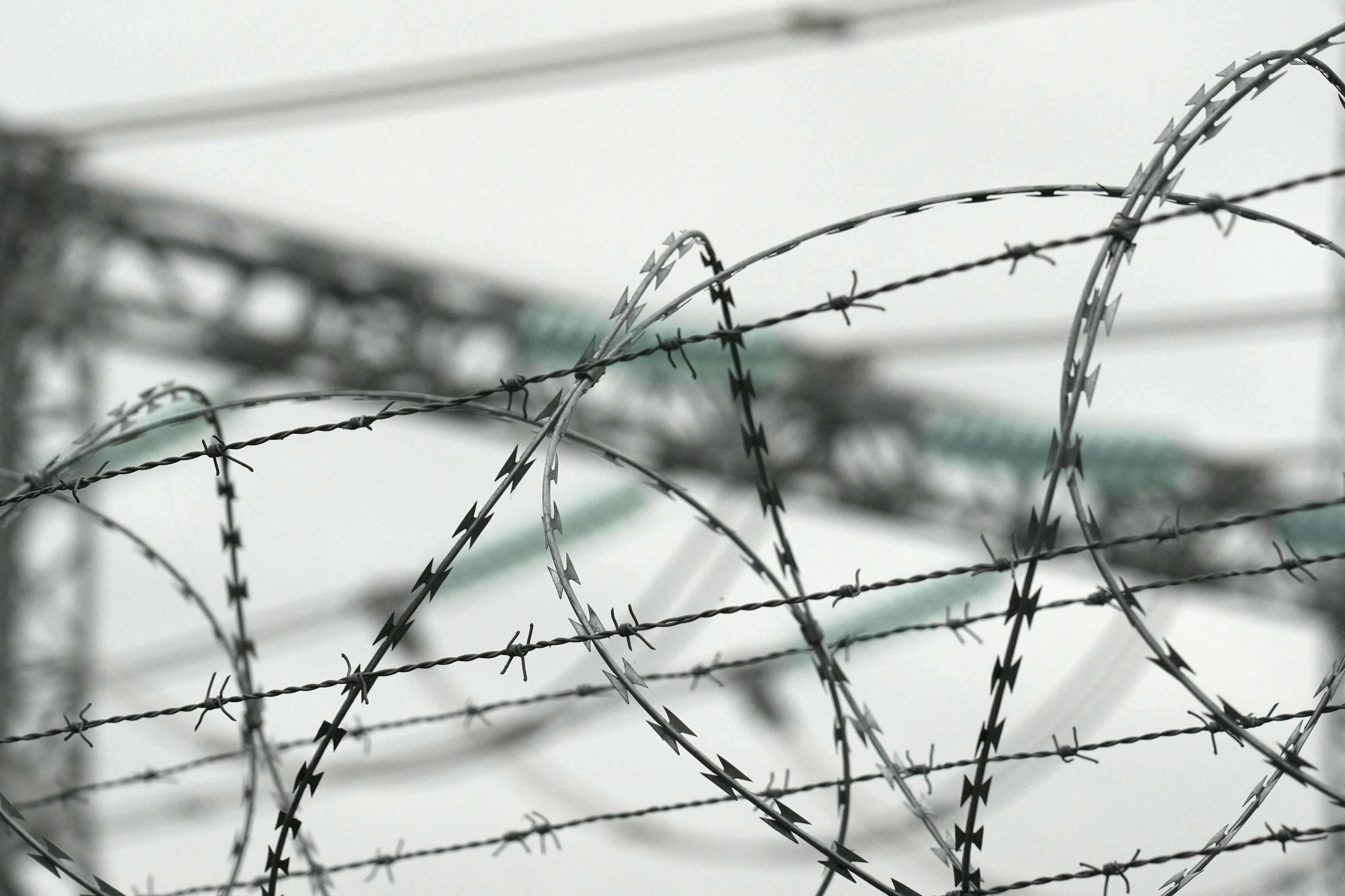 Razor and barbed wires reinforce the fence of Lithuanian power grid operator Litgrid's substation in Nemencine, Lithuania, September 29, 2025. REUTERS/Janis Laizans