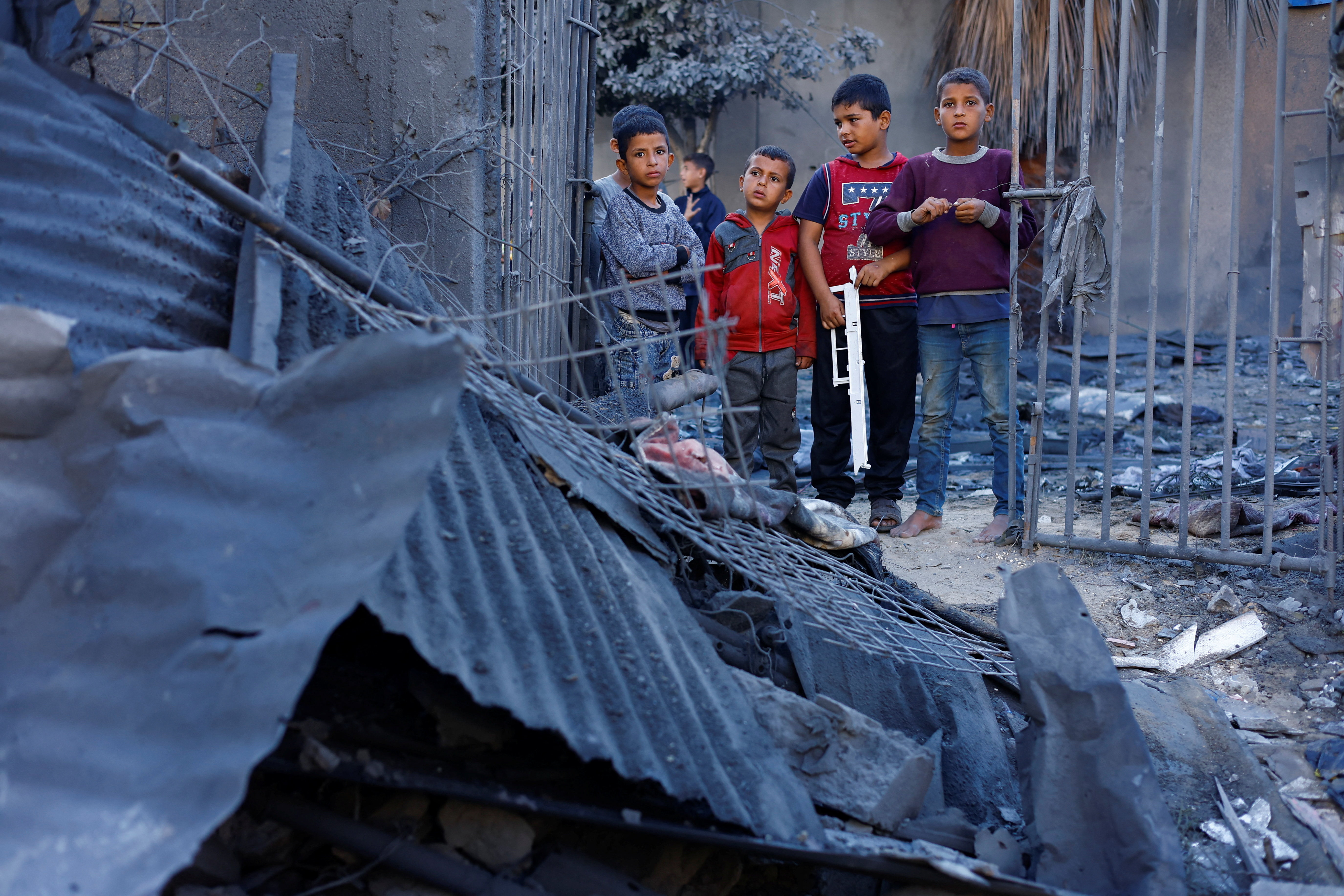 Palestinian children inspect the site of an overnight Israeli strike on a house, in Nuseirat, central Gaza Strip, October 29, 2025. REUTERS/Mahmoud Issa