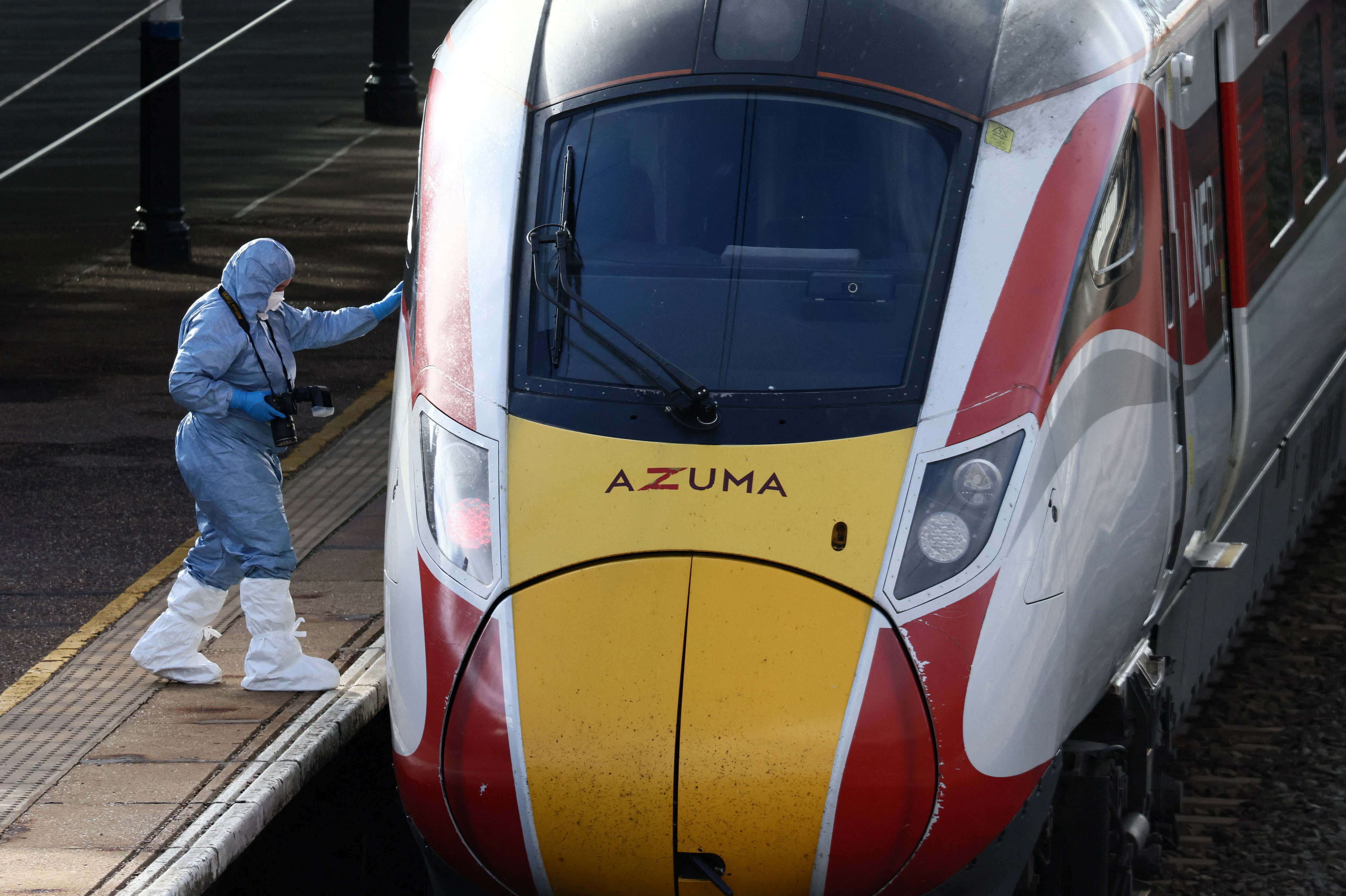 A forensic officer inspects the London North Eastern Railway (LNER) train where a series of stabbings took place, at a platform at Huntingdon Station, near Cambridge, Britain, November 2, 2025. REUTERS/Jack Taylor