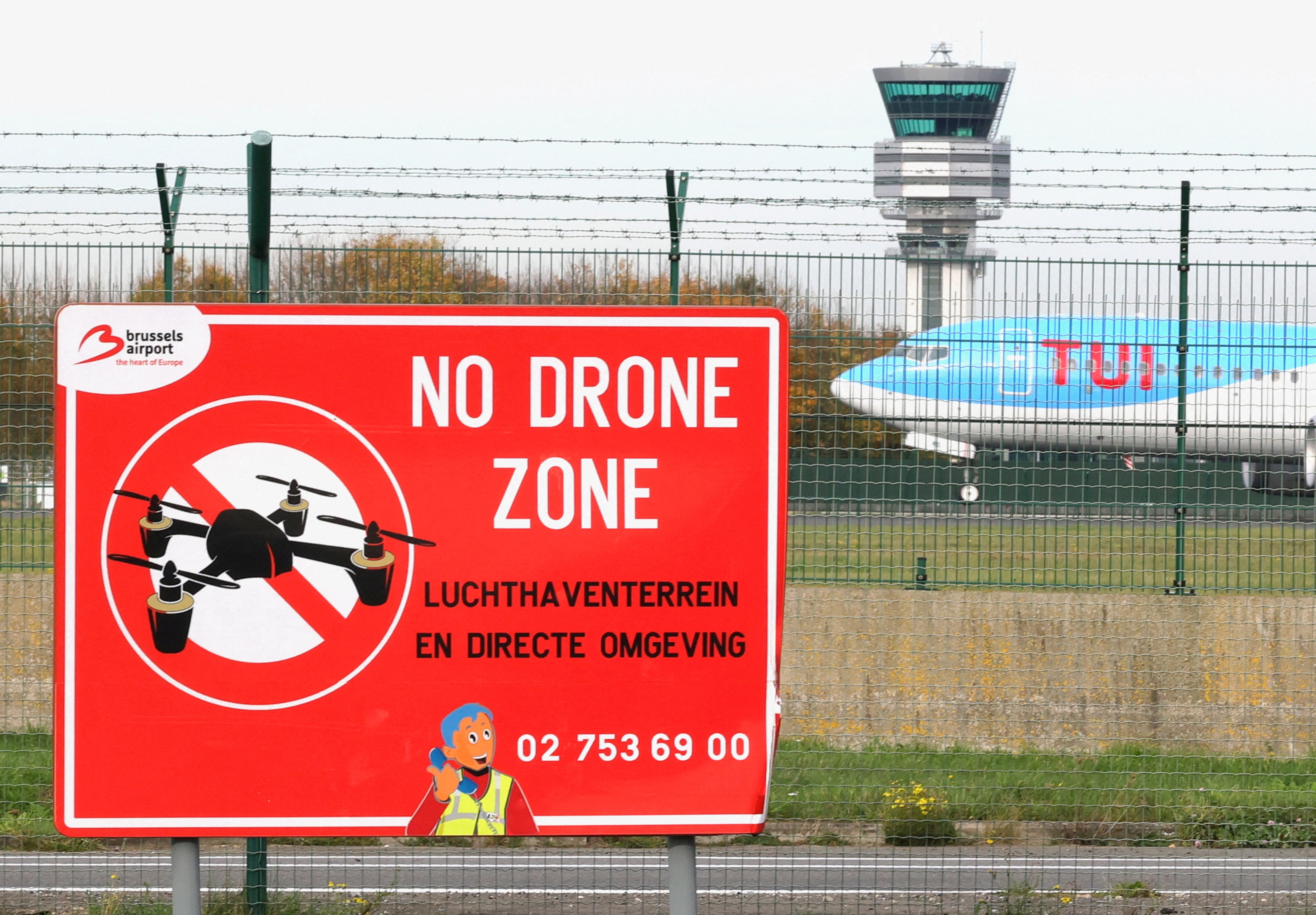 FILE PHOTO: An aircraft lands on the tarmac near a "No Drone Zone" placard on the day of an emergency meeting of Belgian government officials and experts