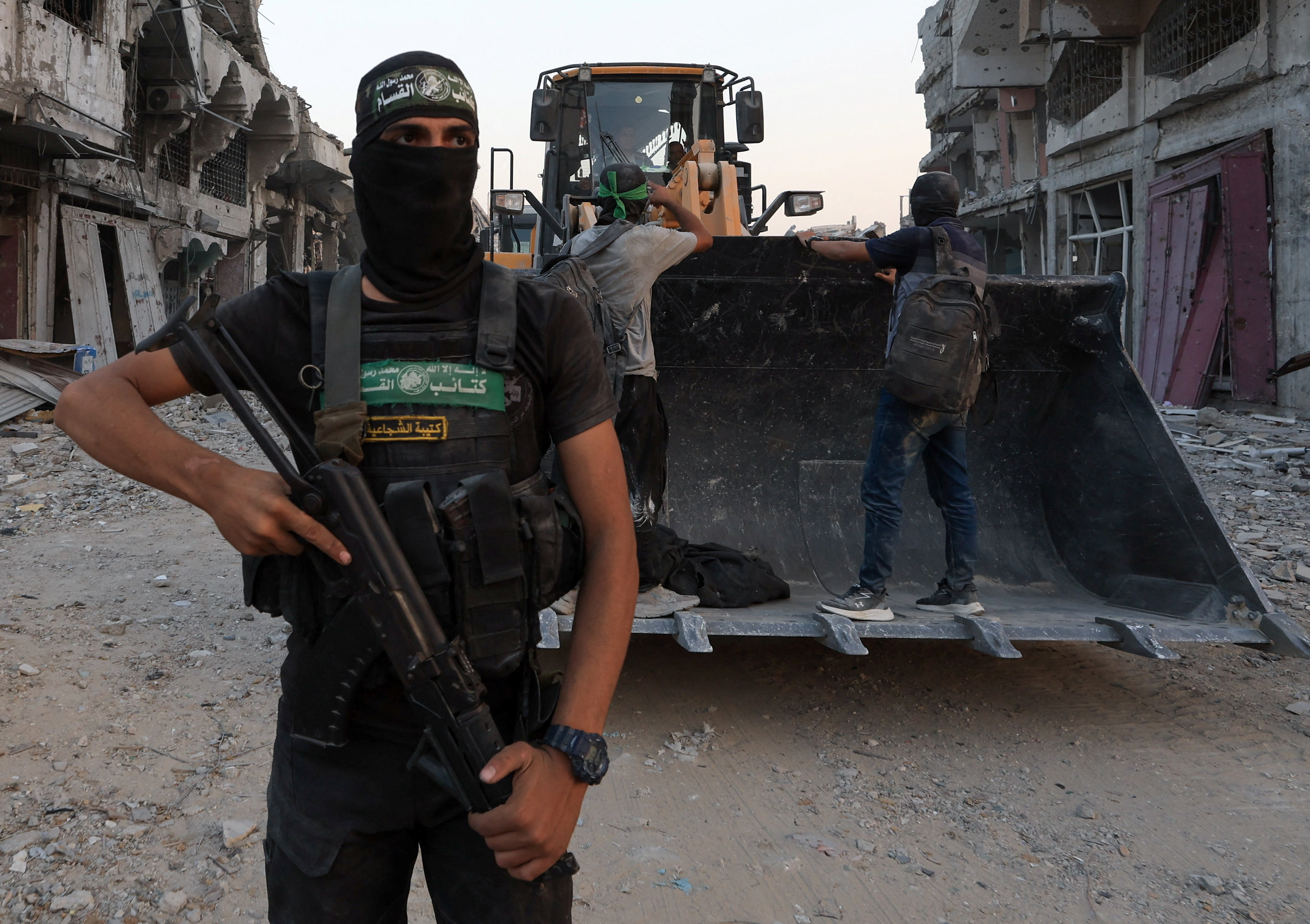 A Palestinian Hamas militant stands next to heavy