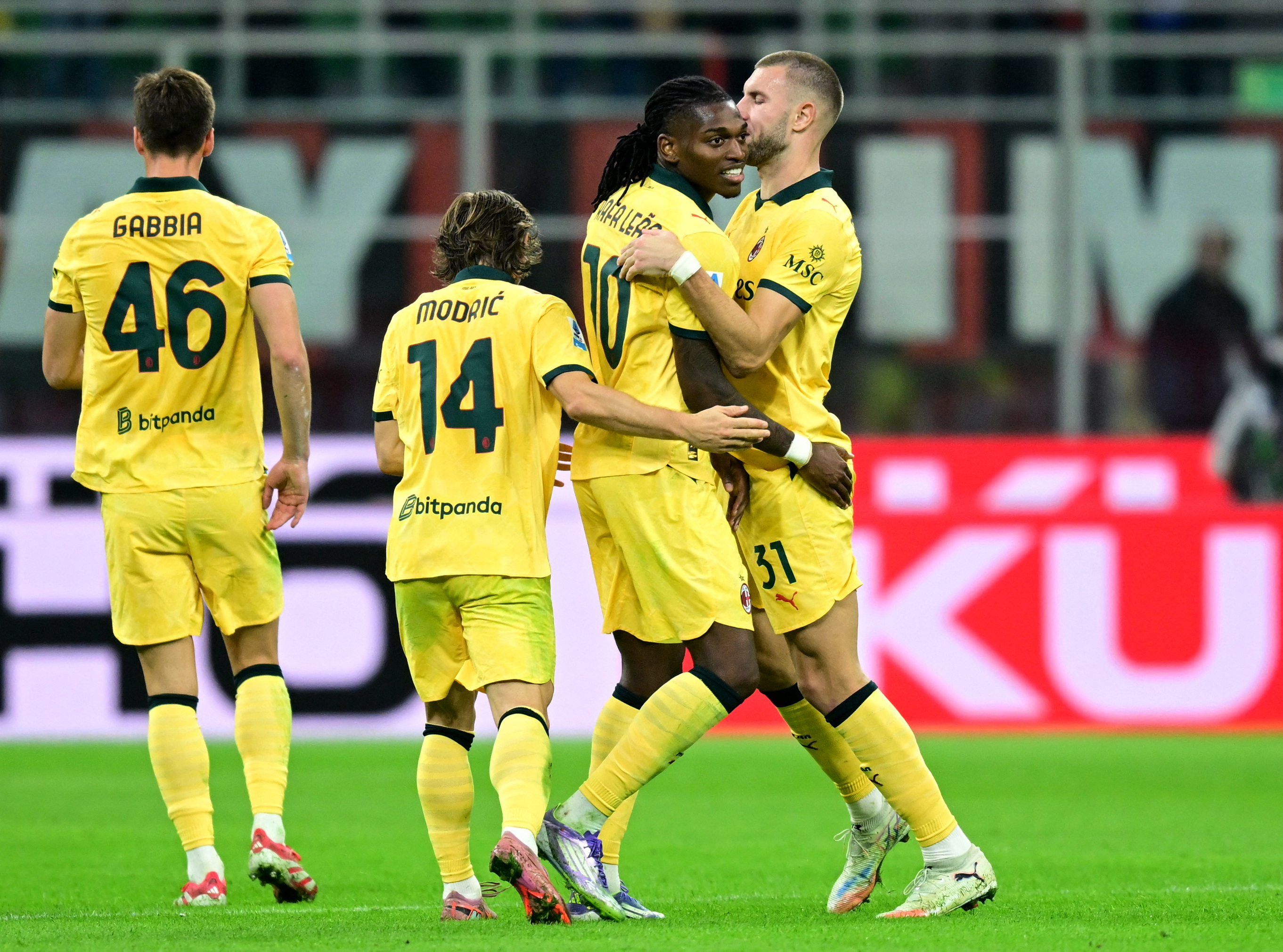 Soccer Football - Serie A - AC Milan v Fiorentina - San Siro, Milan, Italy - October 19, 2025 AC Milan's Rafael Leao celebrates scoring their first goal with Strahinja Pavlovic and Luka Modric REUTERS/Daniele Mascolo