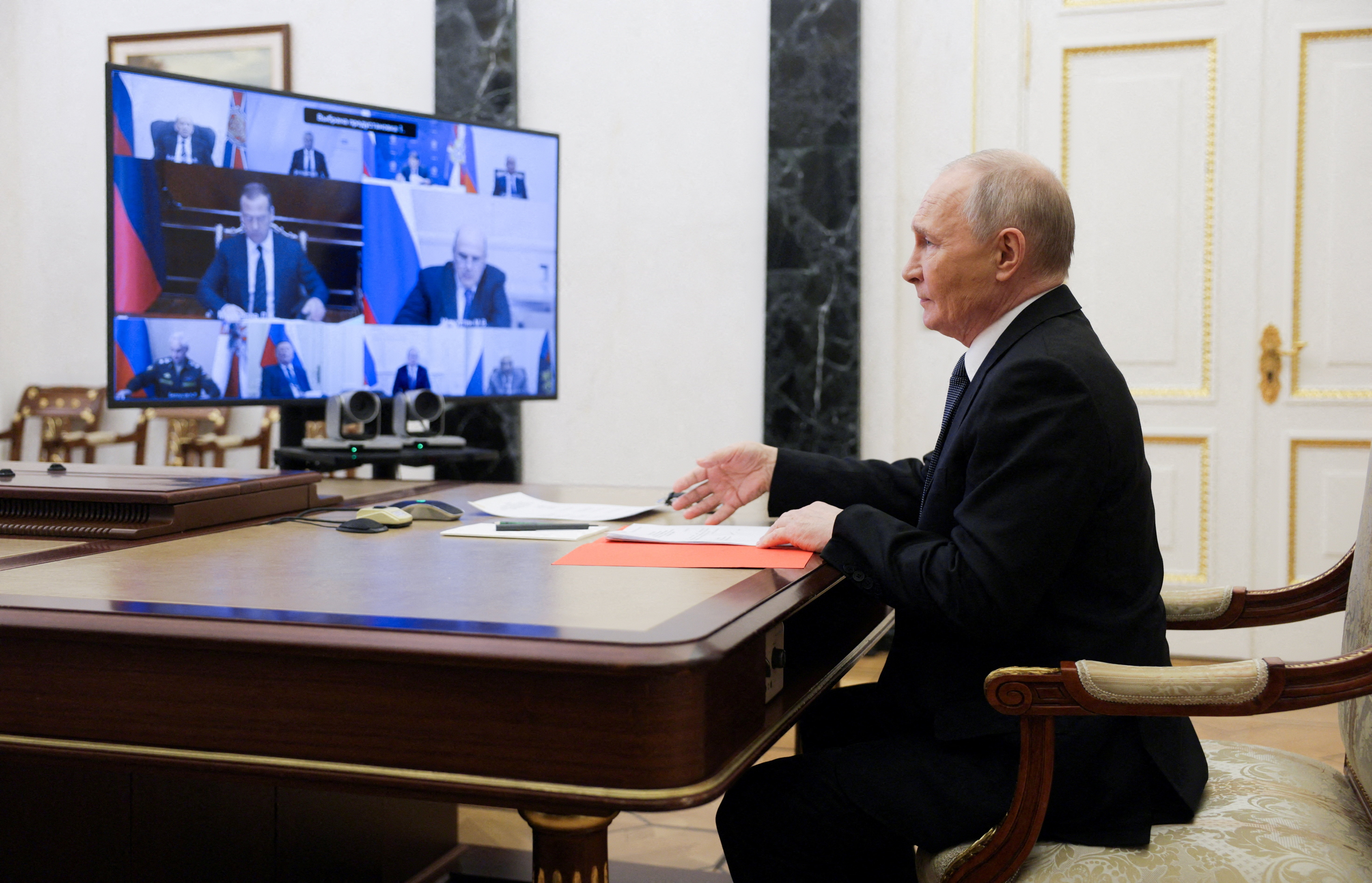 Russian President Vladimir Putin chairs a meeting with