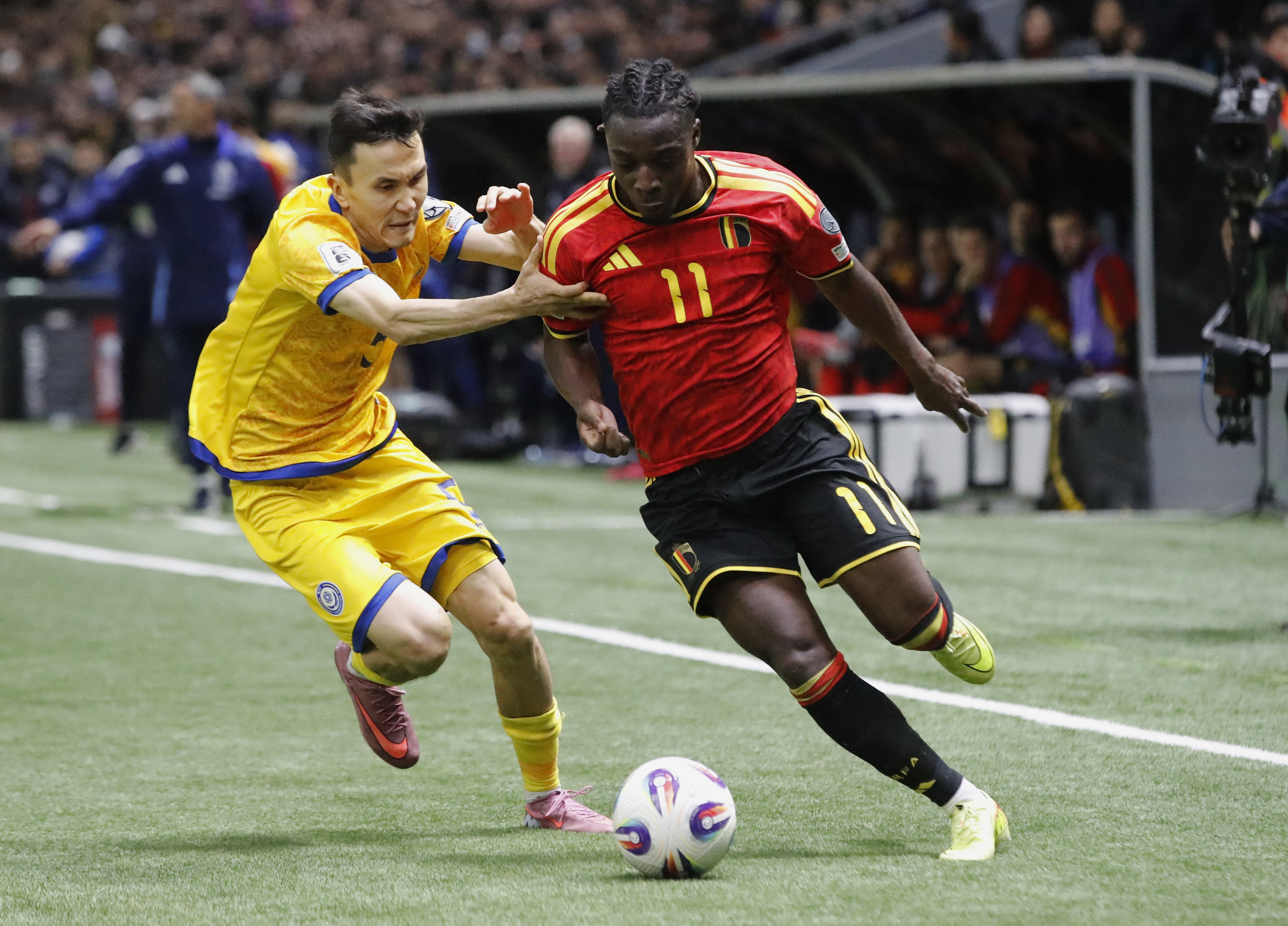 Soccer Football - FIFA World Cup - UEFA Qualifiers - Group J - Kazakhstan v Belgium - Astana Arena, Astana, Kazakhstan - November 15, 2025 Belgium's Jeremy Doku in action with Kazakhstan's Bagdat Kairov REUTERS/Pavel Mikheyev