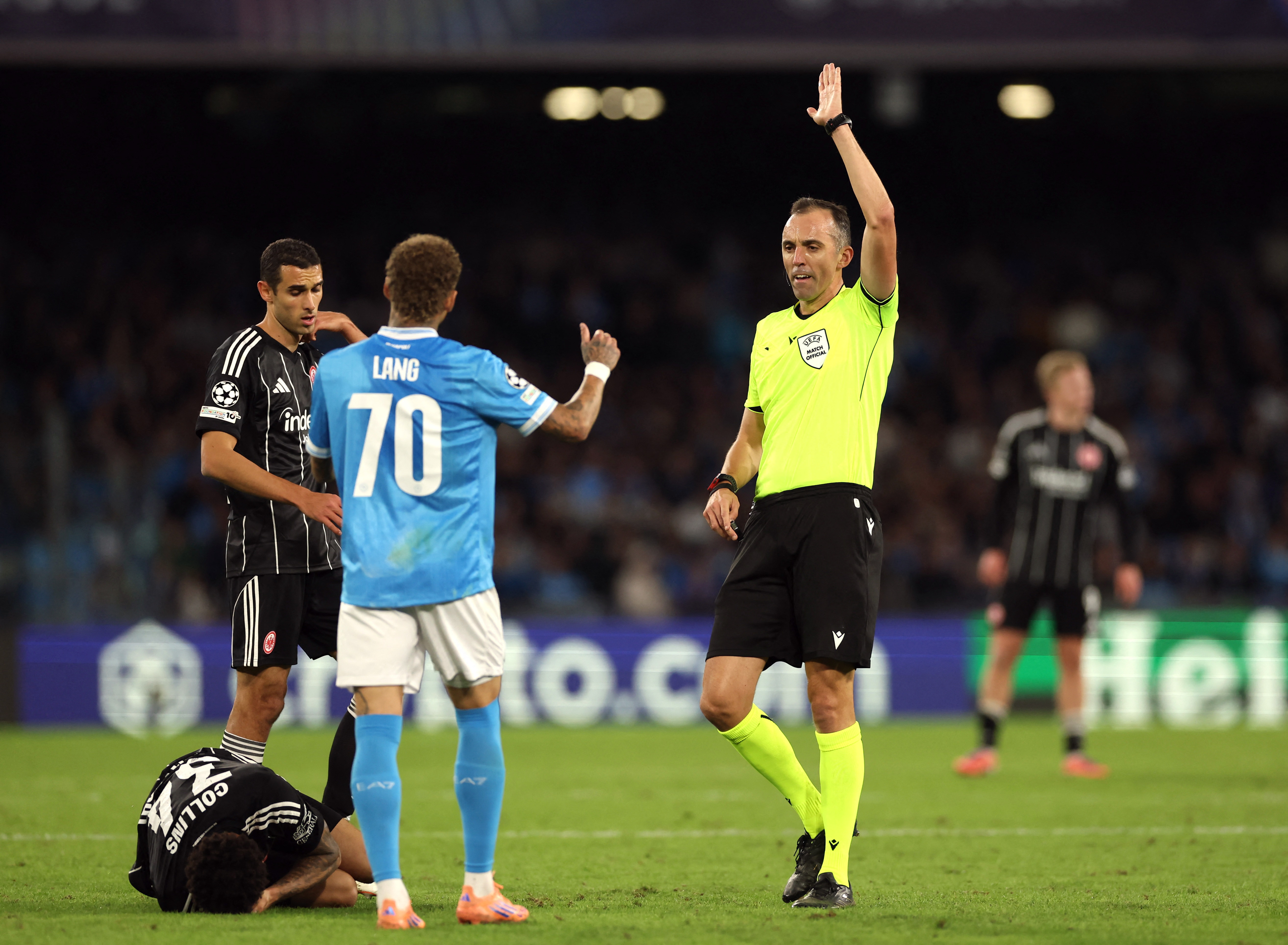 Soccer Football - UEFA Champions League - Napoli v Eintracht Frankfurt - Stadio Diego Armando Maradona, Naples, Italy - November 4, 2025 Referee Joao Pinheiro reacts as Napoli's Noa Lang looks on REUTERS/Ciro De Luca