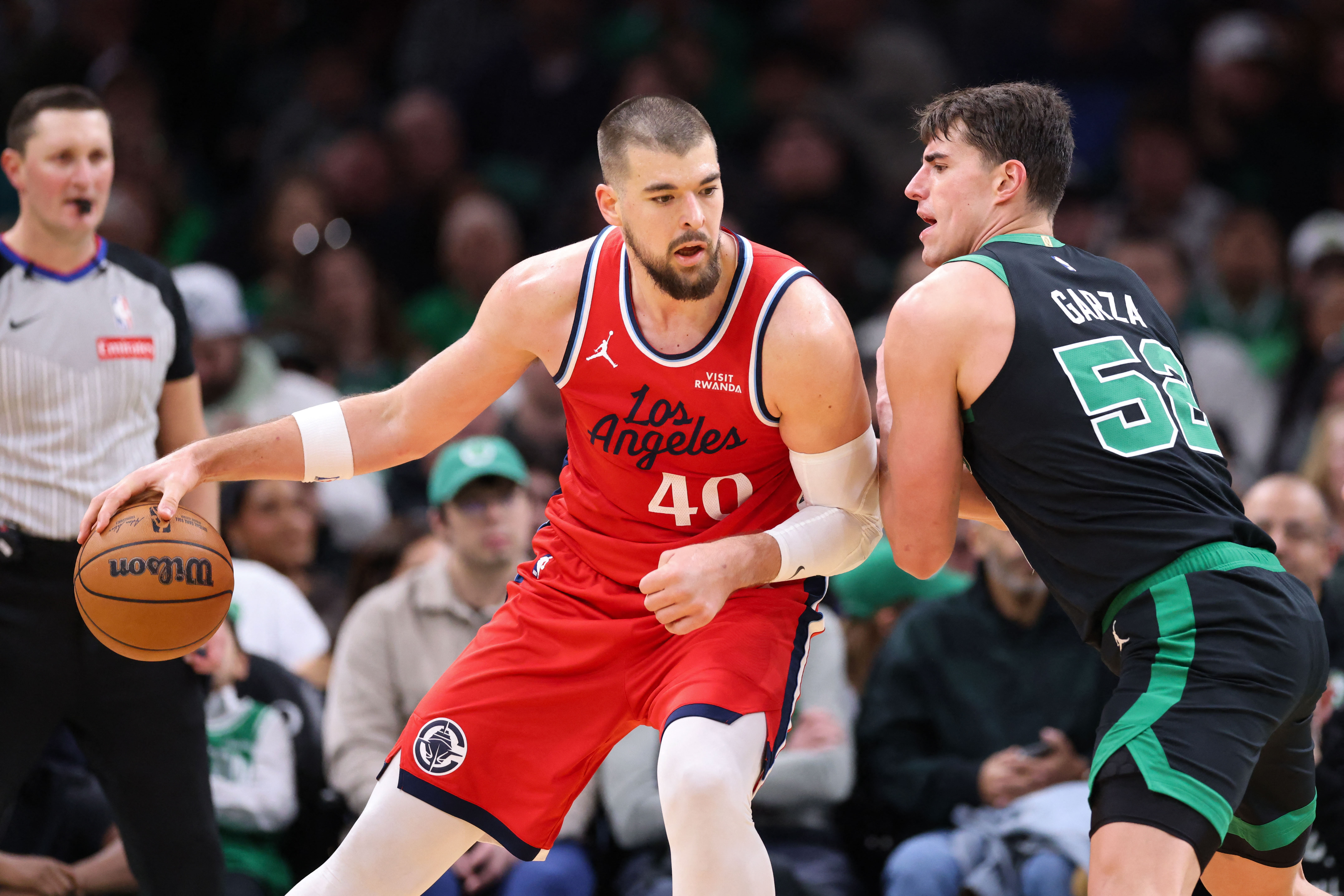Nov 16, 2025; Boston, Massachusetts, USA; Boston Celtics forward Luka Garza (52) defends Los Angeles Clippers center Ivica Zubac (40) during the first half at TD Garden. Mandatory Credit: Paul Rutherford-Imagn Images