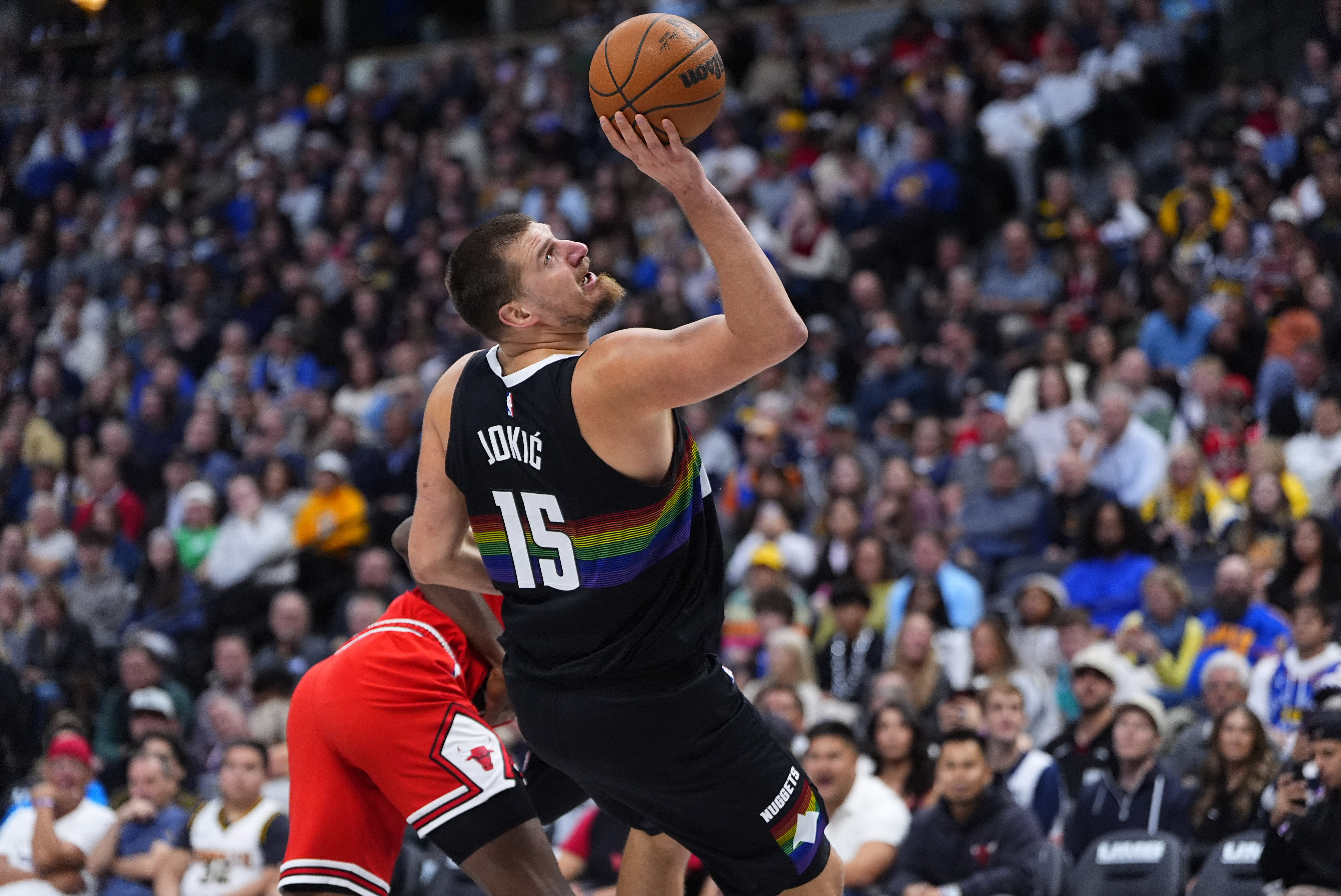 Nov 17, 2025; Denver, Colorado, USA; Denver Nuggets center Nikola Jokic (15) shoots the ball in the second half against the Chicago Bulls at Ball Arena. Mandatory Credit: Ron Chenoy-Imagn Images