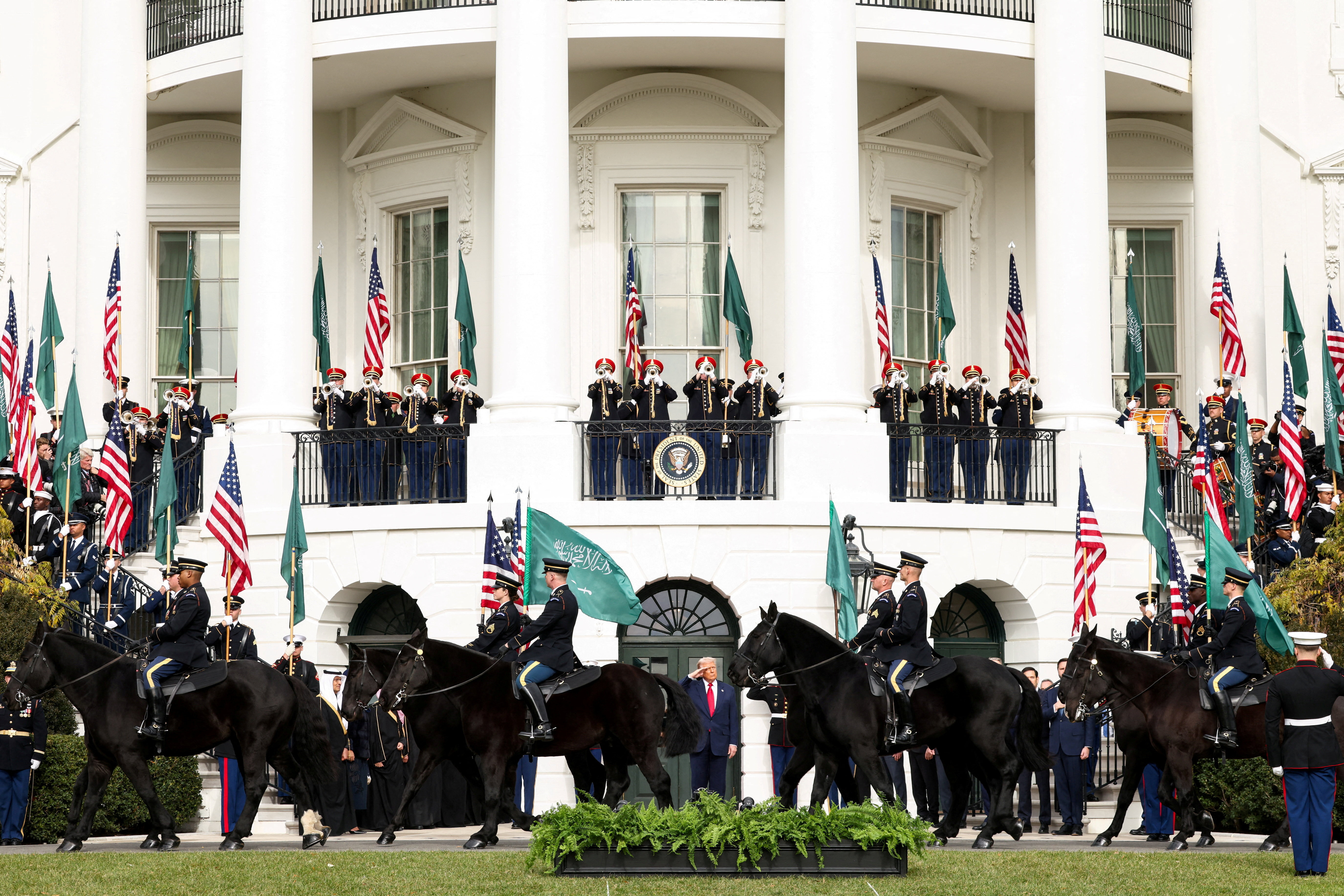 U.S. President Donald Trump observes a procession of horses passing the White House ahead of the arrival of Saudi Crown Prince and Prime Minister Mohammed bin Salman, in Washington, D.C., U.S., November 18, 2025. REUTERS/Kevin Lamarque