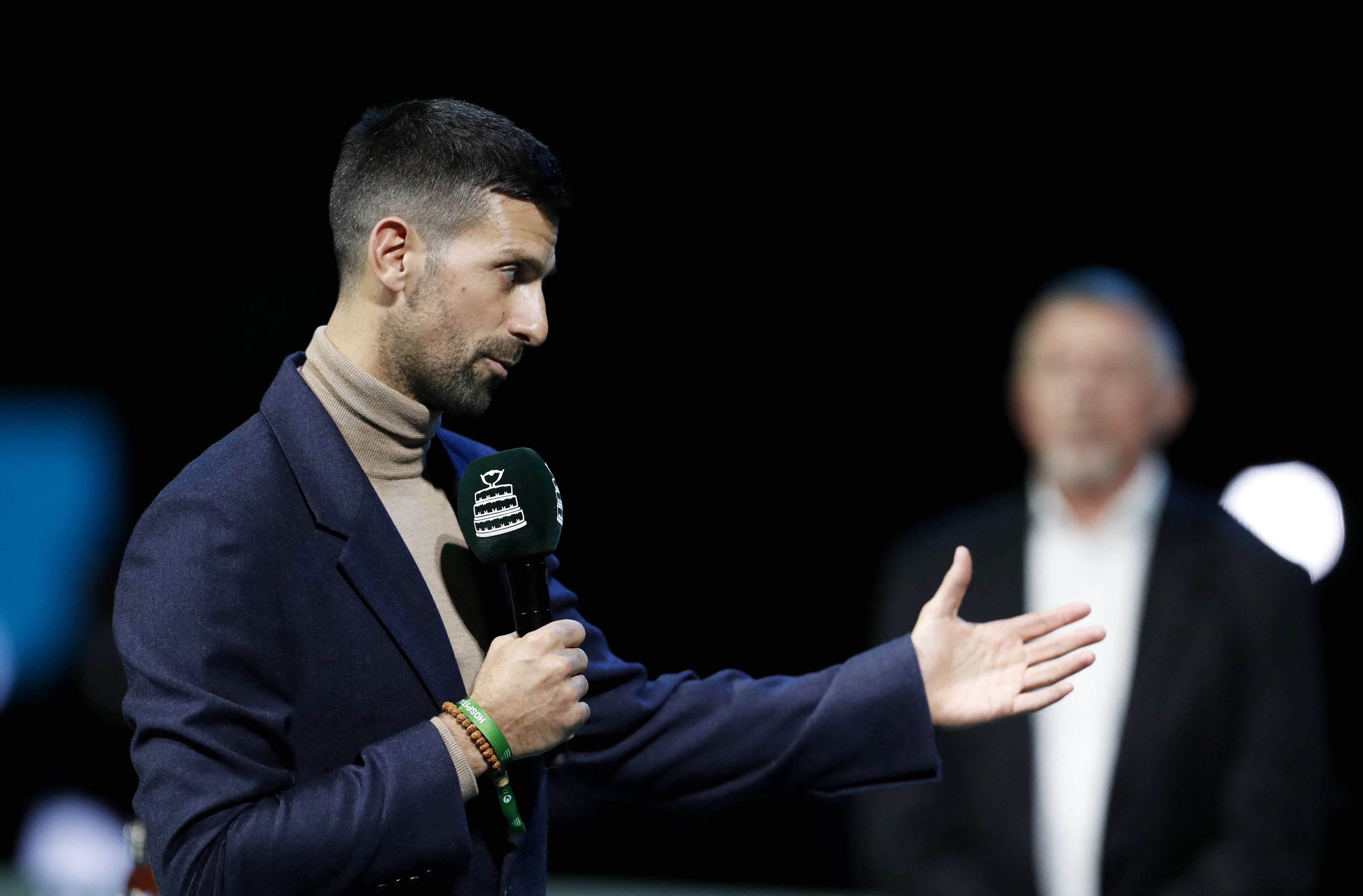 Tennis - Davis Cup - Final 8 - Italy v Austria - Unipol Arena, Bologna, Italy - November 19, 2025 Serbia's Novak Djokovic speaks during a tribute ceremony for former player Croatia's Nikola Pilic before the match REUTERS/Alessandro Garofalo