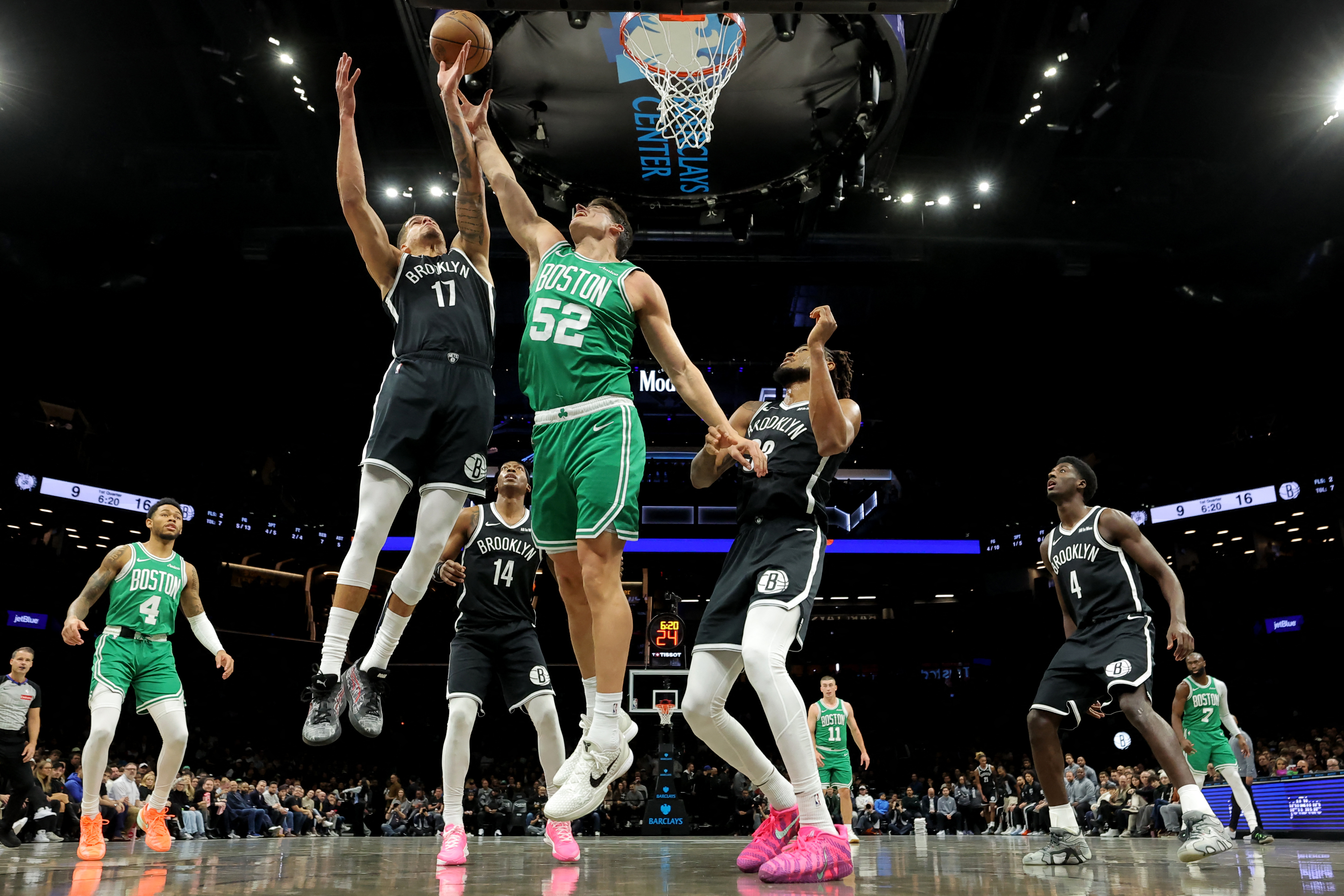 Nov 18, 2025; Brooklyn, New York, USA; Boston Celtics center Luka Garza (52) fights for a rebound against Brooklyn Nets forward Michael Porter Jr. (17) and guard Terance Mann (14) and center Nic Claxton (33) during the first quarter at Barclays Center. Ma