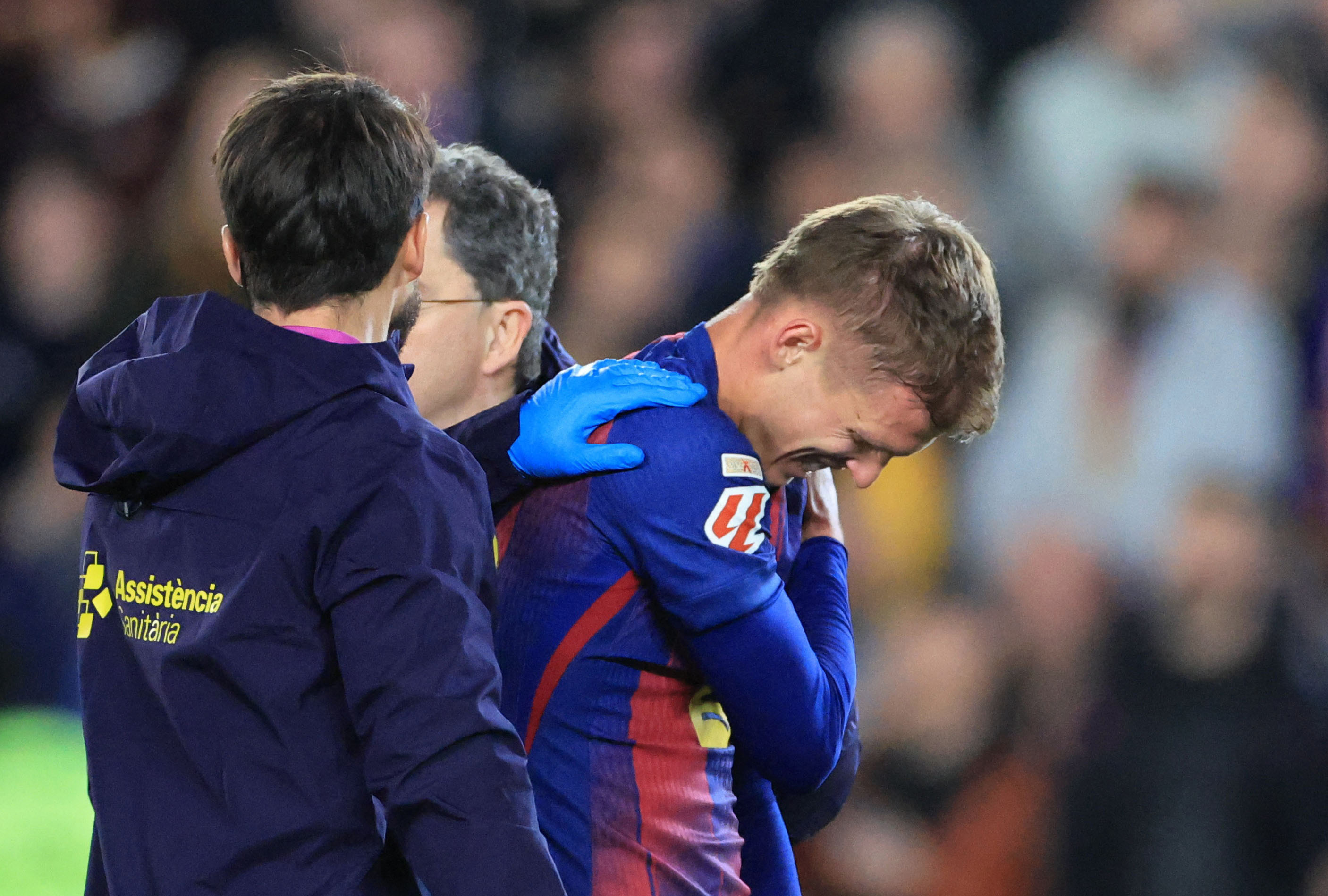 Soccer Football - LaLiga - FC Barcelona v Atletico Madrid - Spotify Camp Nou, Barcelona, Spain - December 2, 2025 FC Barcelona's Dani Olmo is substituted off after sustaining an injury REUTERS/Nacho Doce