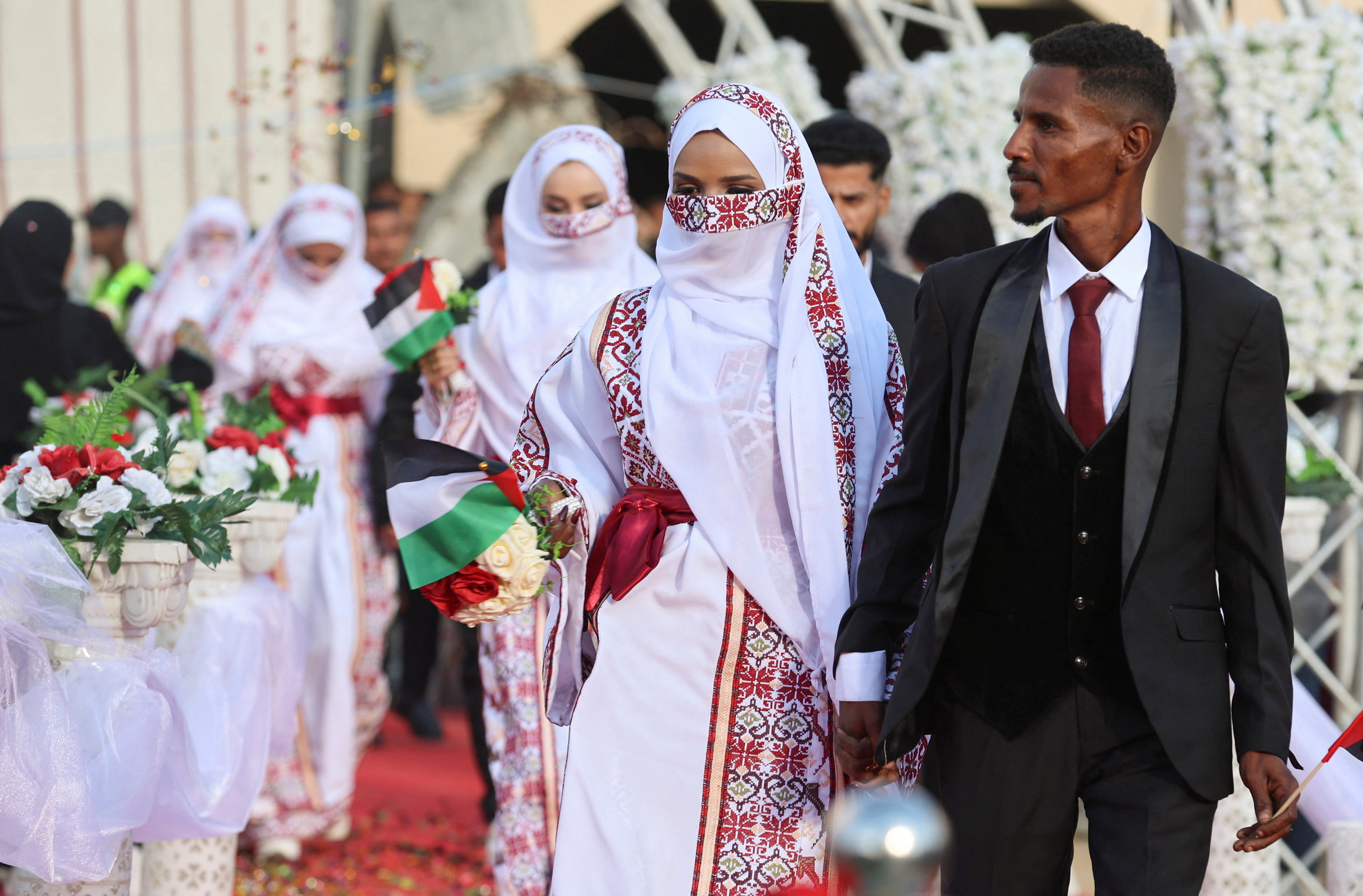 Palestinian couples attend a mass wedding in Khan Younis