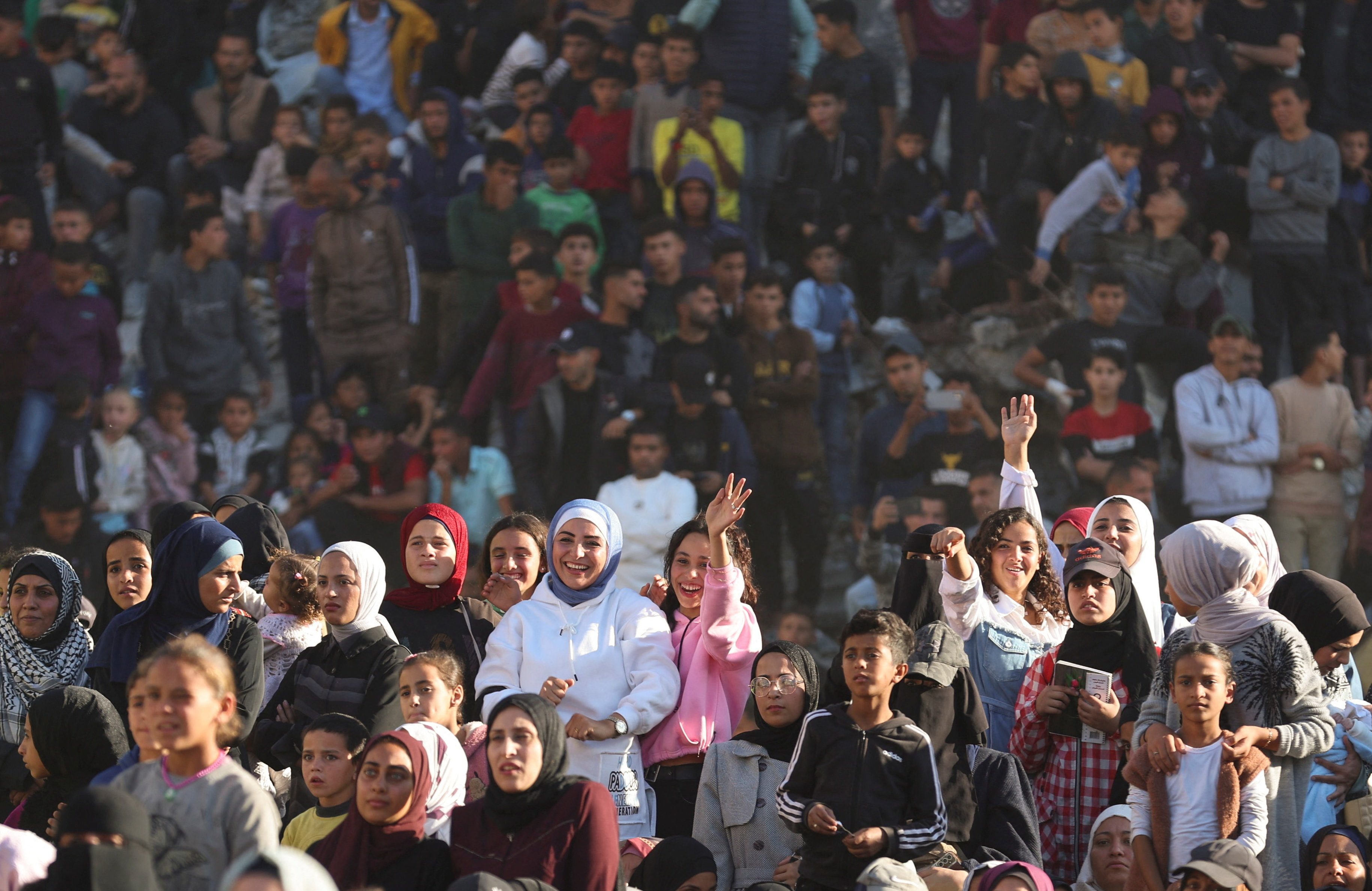 Palestinians watch a mass wedding for 54 couples in Khan Younis, in the southern Gaza Strip December 2, 2025. REUTERS/Ramadan Abed