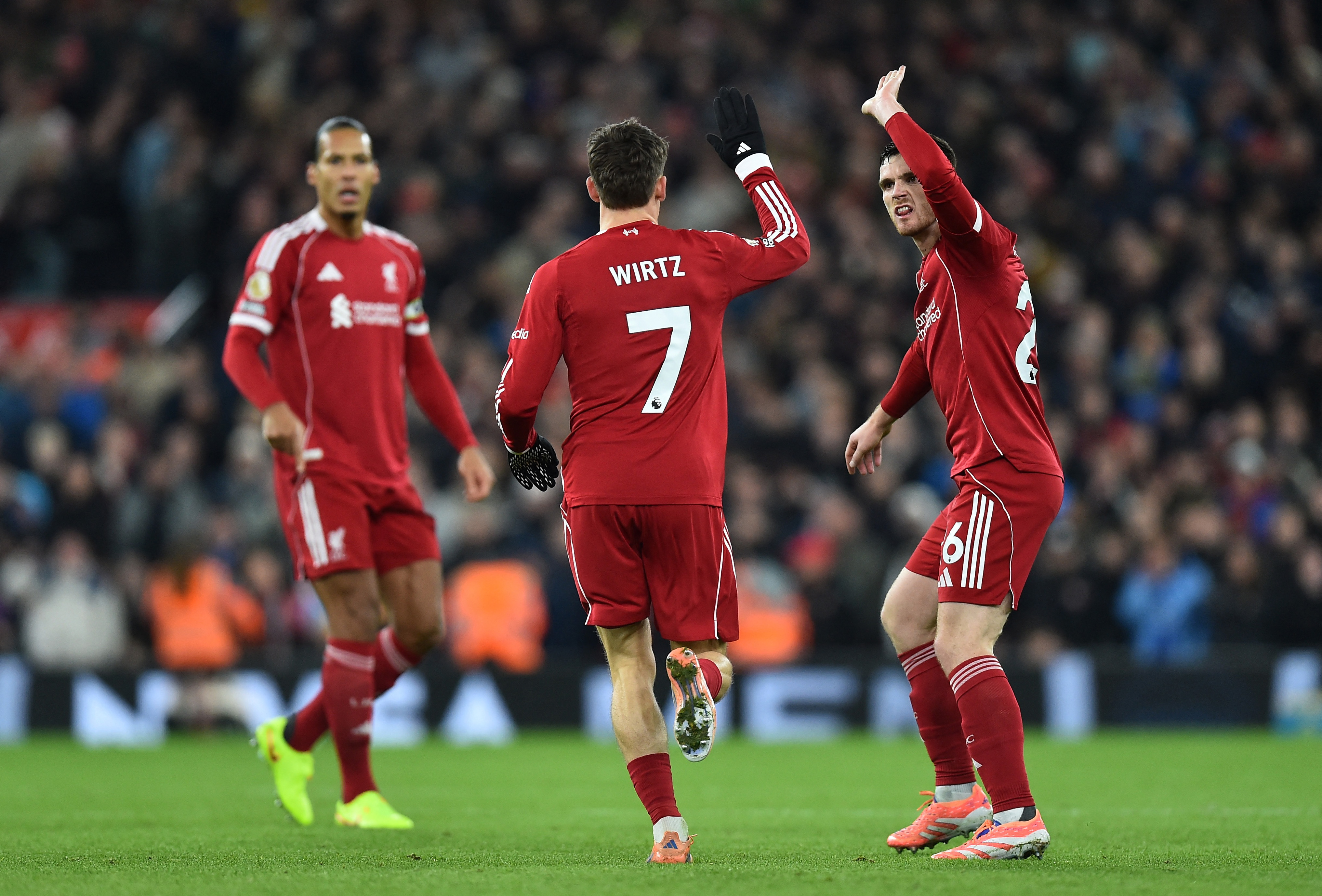 Soccer Football - Premier League - Liverpool v Sunderland - Anfield, Liverpool, Britain - December 3, 2025 Liverpool's Florian Wirtz celebrates scoring their first goal with Andy Robertson REUTERS/Peter Powell EDITORIAL USE ONLY. NO USE WITH UNAUTHORIZED