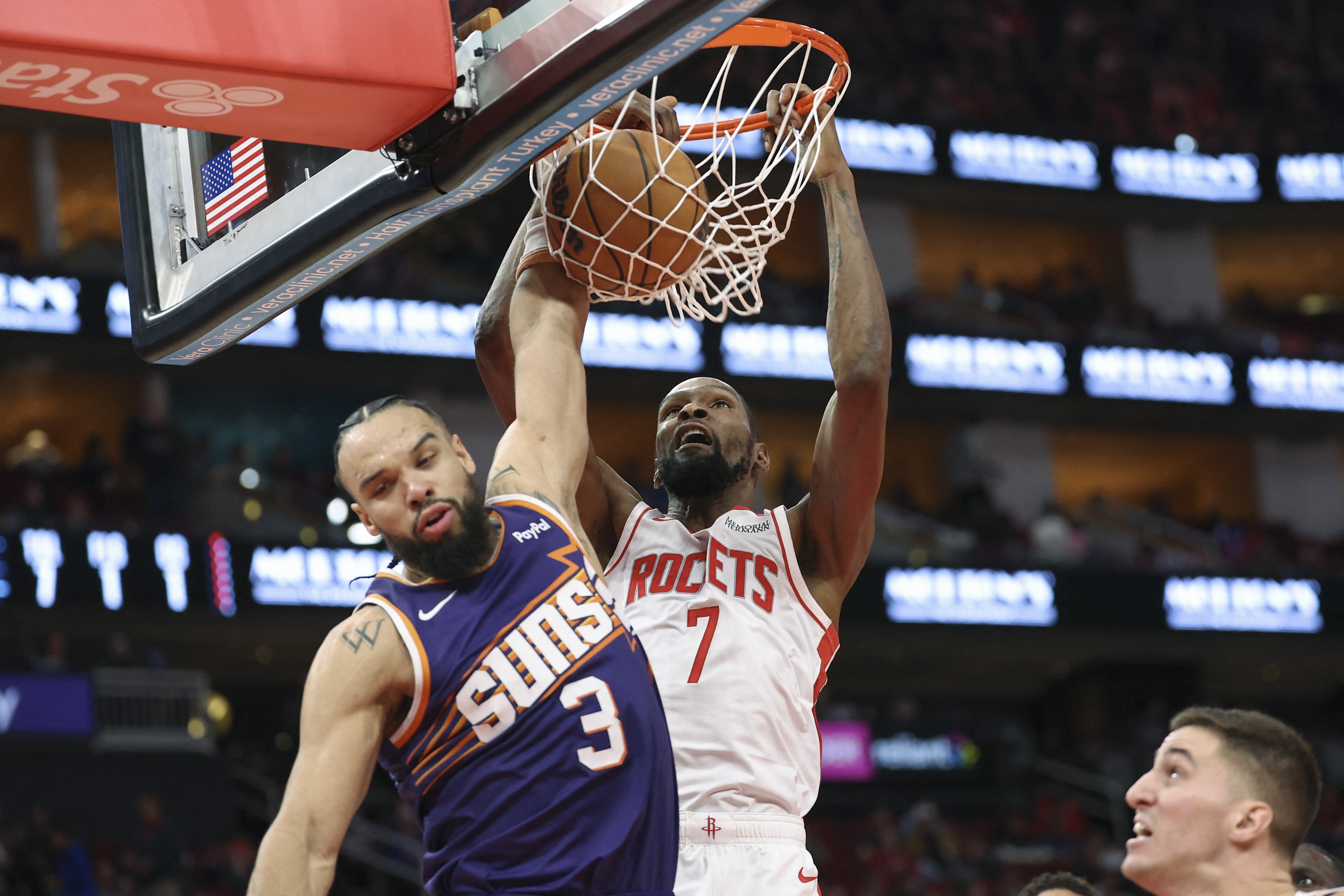 Dec 5, 2025; Houston, Texas, USA; Houston Rockets forward Kevin Durant (7) dunks the ball as Phoenix Suns forward Dillon Brooks (3) defends during the second quarter at Toyota Center. Mandatory Credit: Troy Taormina-Imagn Images