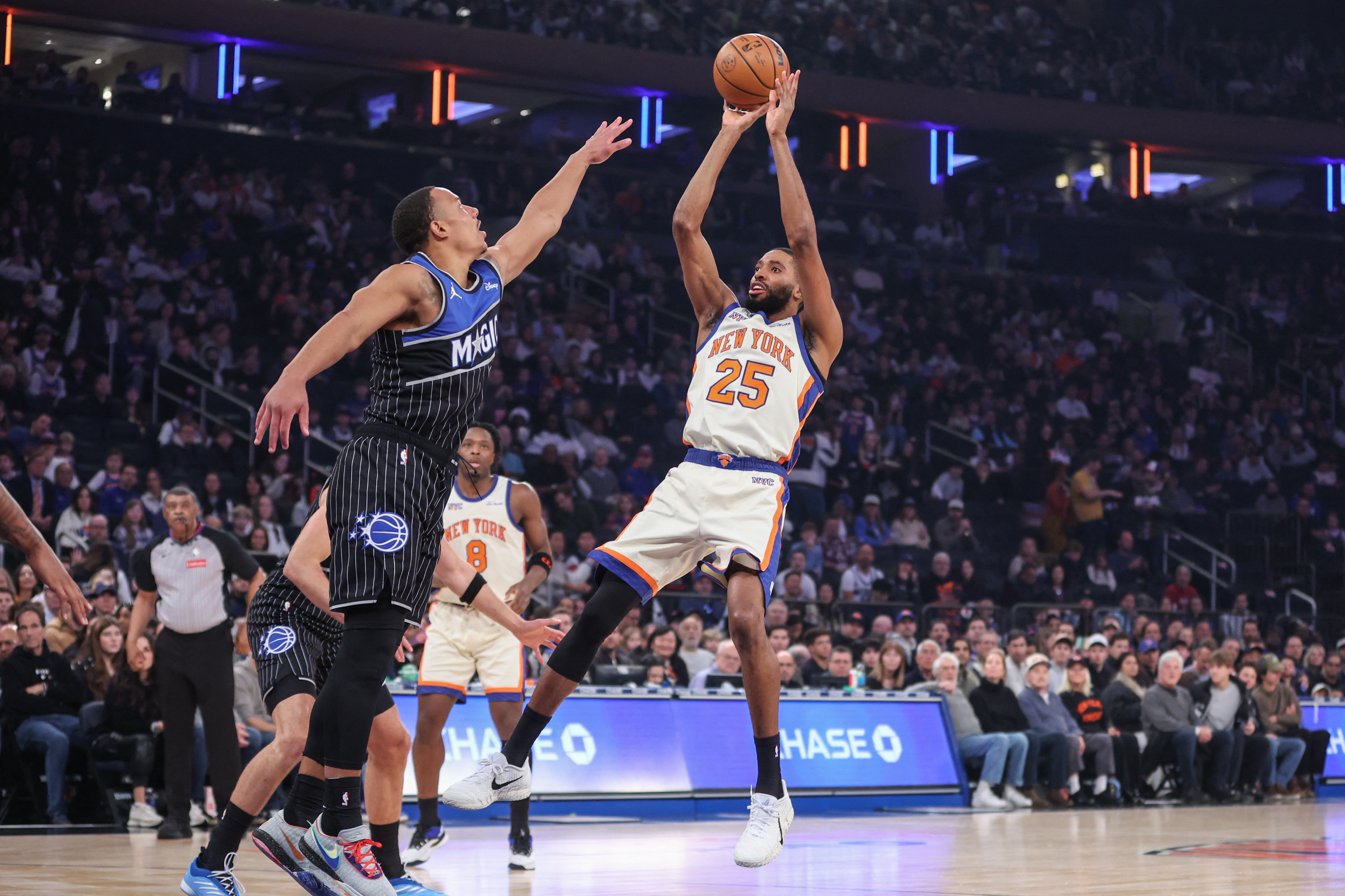 Dec 7, 2025; New York, New York, USA;  New York Knicks guard Mikal Bridges (25) shoots past Orlando Magic guard Desmond Bane (3) in the first quarter at Madison Square Garden. Mandatory Credit: Wendell Cruz-Imagn Images