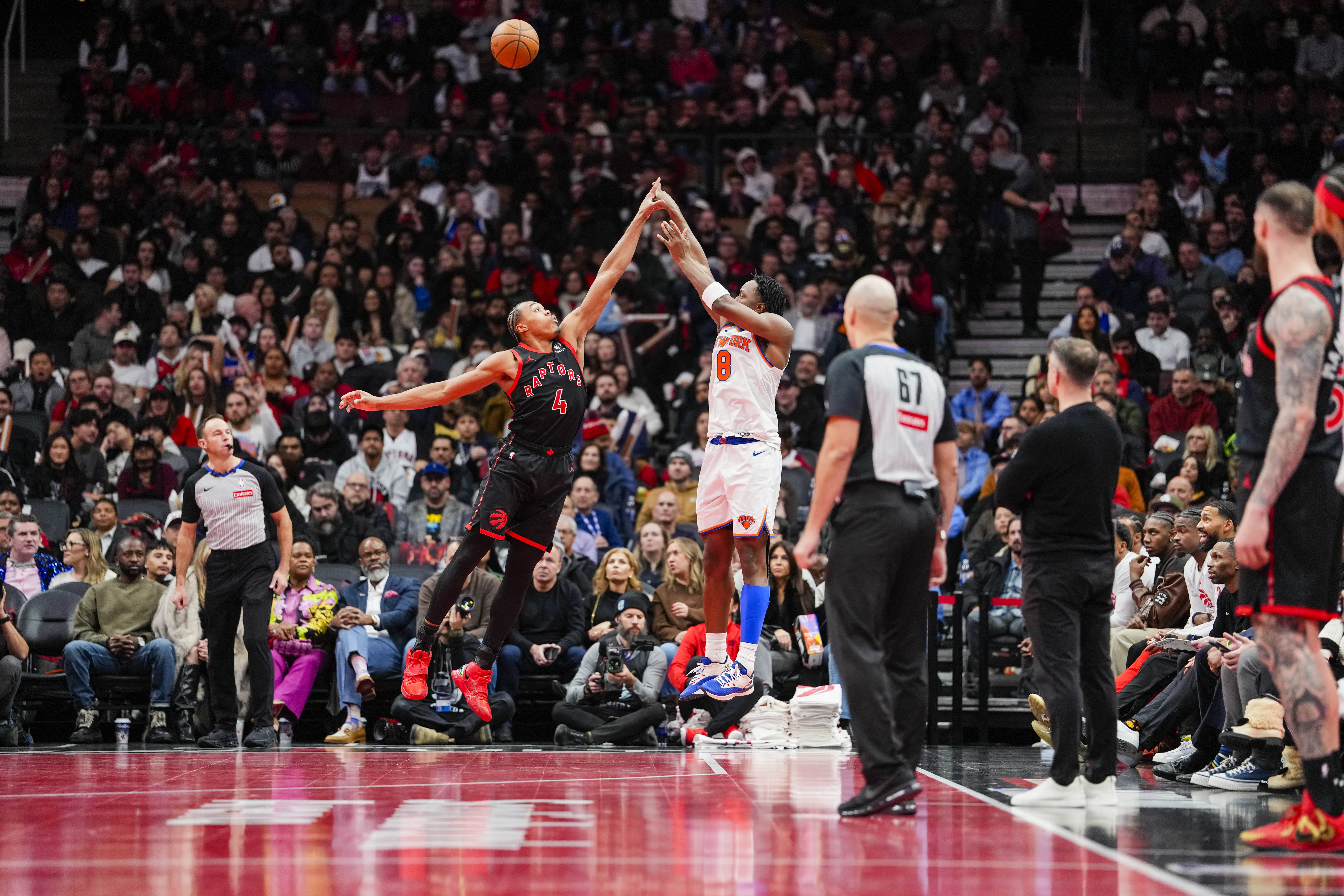 Dec 9, 2025; Toronto, Ontario, CAN; New York Knicks forward Og Anunoby (8) shoots over Toronto Raptors forward Scottie Barnes (4) during the second half at the 2025-26 NBA Emirates Cup at Scotiabank Arena. Mandatory Credit: Kevin Sousa-Imagn Images