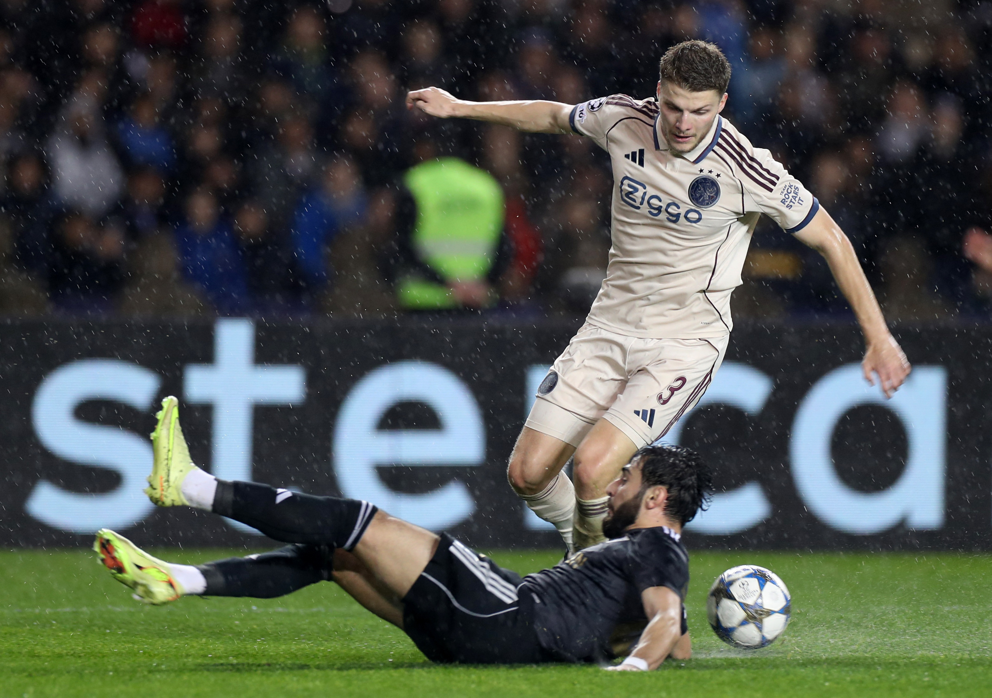 Soccer Football - UEFA Champions League - Qarabag v Ajax Amsterdam - Tofiq Bahramov Republican Stadium, Baku, Azerbaijan - December 10, 2025 Ajax Amsterdam's Anton Gaaei in action with Qarabag's Elvin Cafarquliyev REUTERS/Aziz Karimov