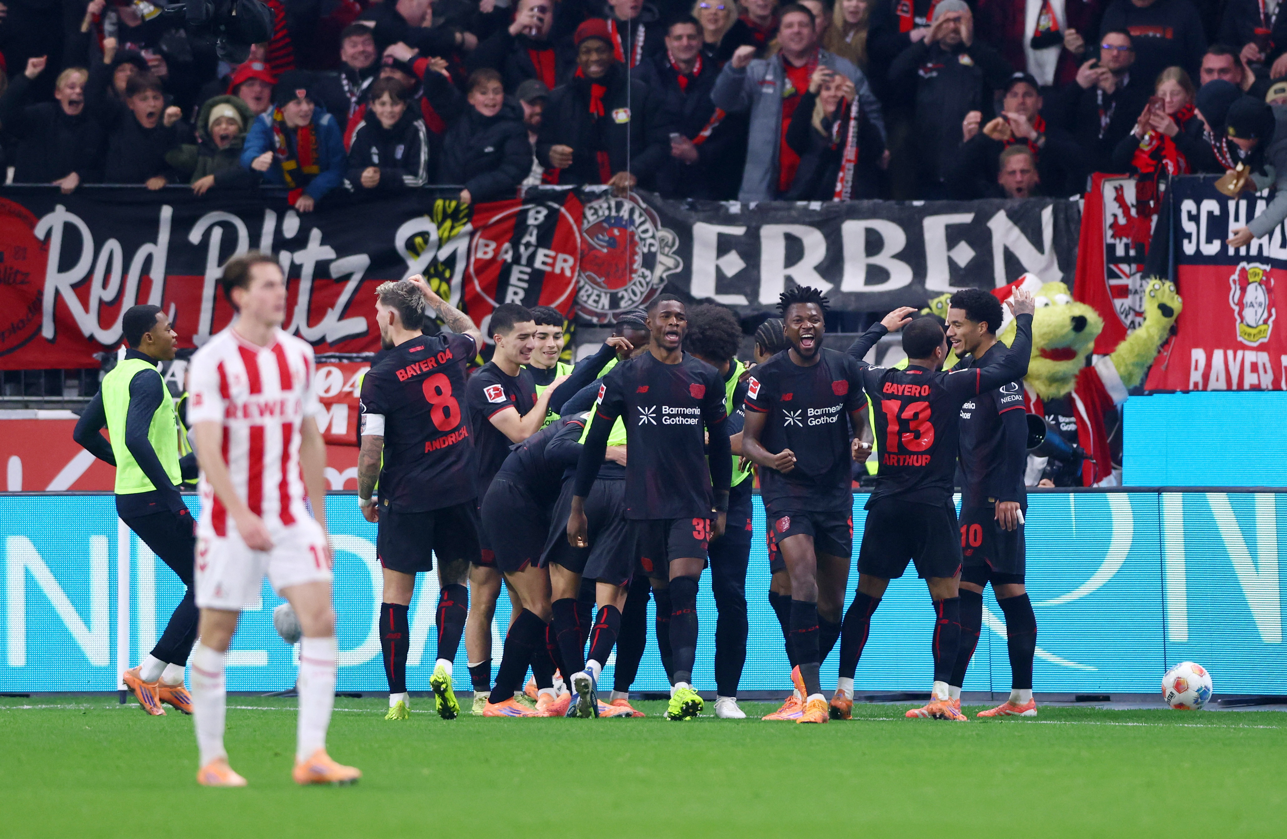 Soccer Football - Bundesliga - Bayer Leverkusen v FC Cologne - BayArena, Leverkusen, Germany - December 13, 2025 Bayer Leverkusen's Martin Terrier celebrates scoring their first goal with teammates REUTERS/Thilo Schmuelgen DFL REGULATIONS PROHIBIT ANY USE