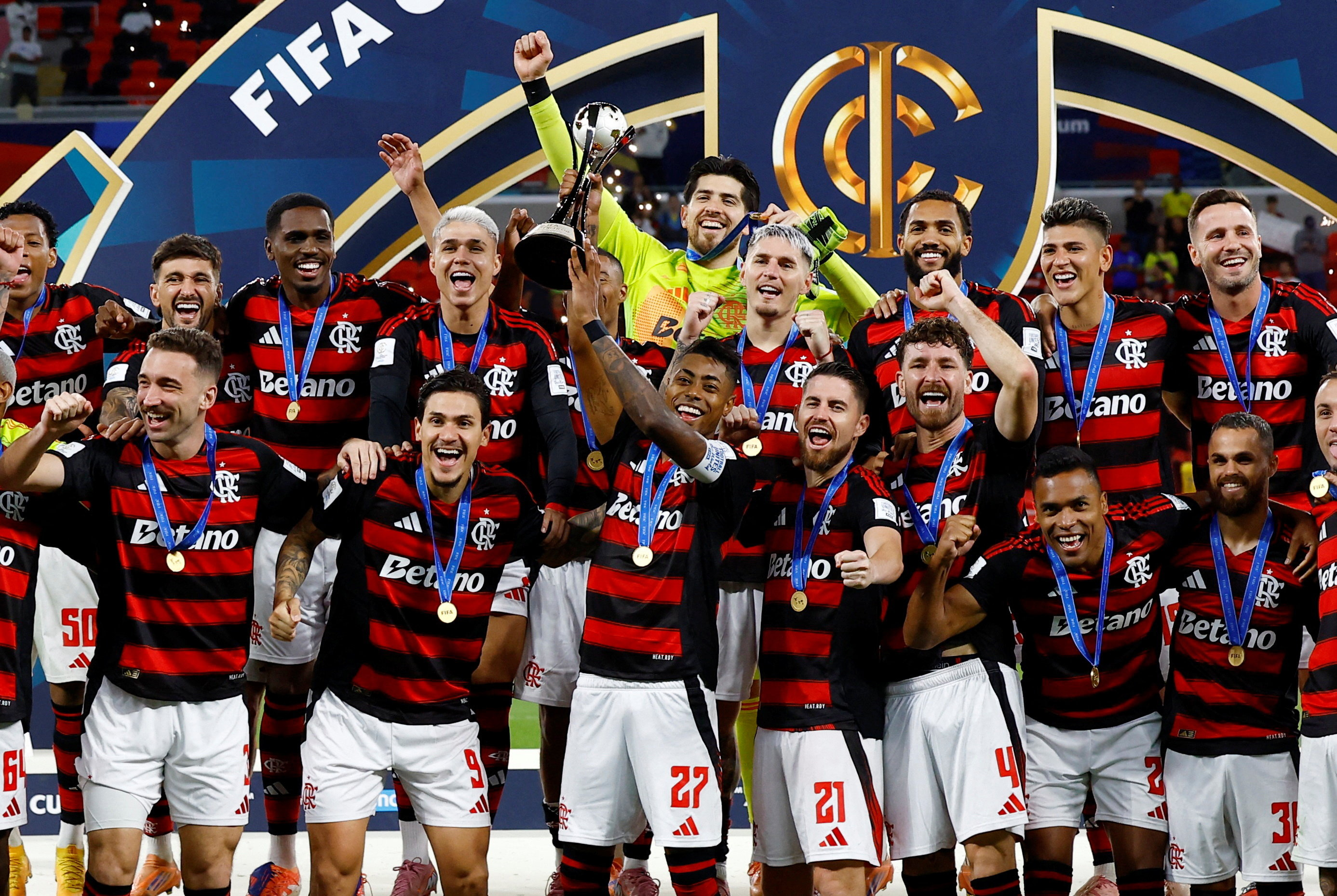 Soccer Football - FIFA Challenger Cup - Flamengo v Pyramids FC - Ahmad Bin Ali Stadium, Al-Rayyan, Qatar - December 13, 2025 Flamengo's Bruno Henrique lifts the trophy as he celebrates with teammates after winning the Challenger Cup REUTERS/Rula Rouhana